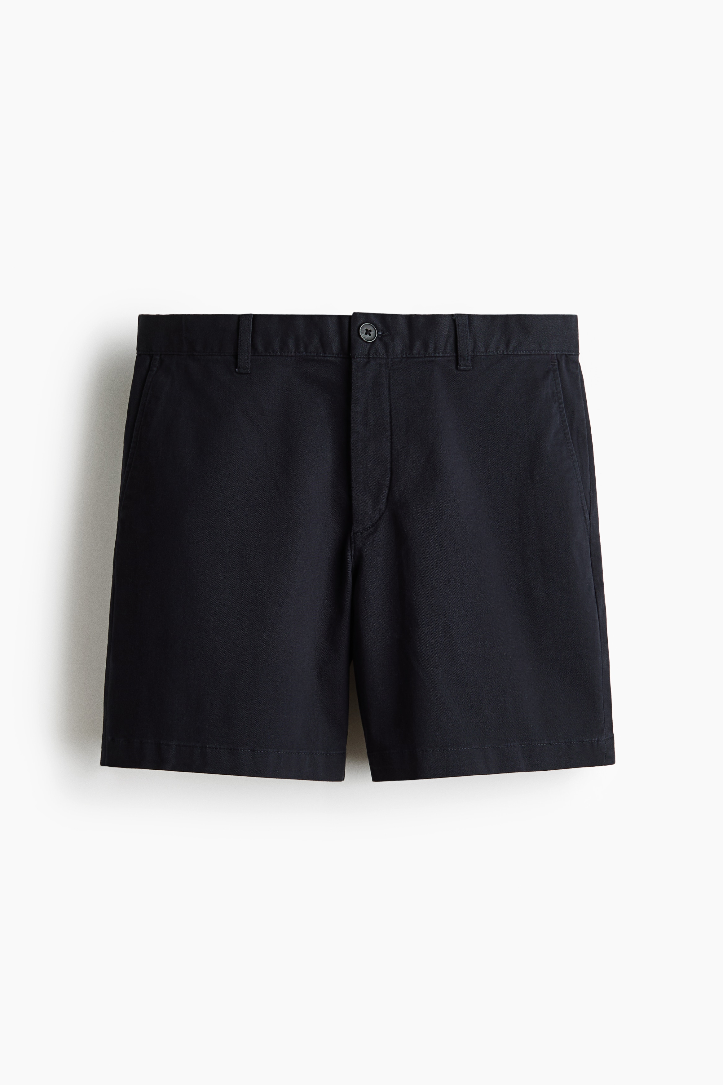 Dark chino shorts in a regular fit are being worn by the model, styled with a striped henley shirt and an open denim shirt. The shorts feature a classic silhouette and sit just above the knee.