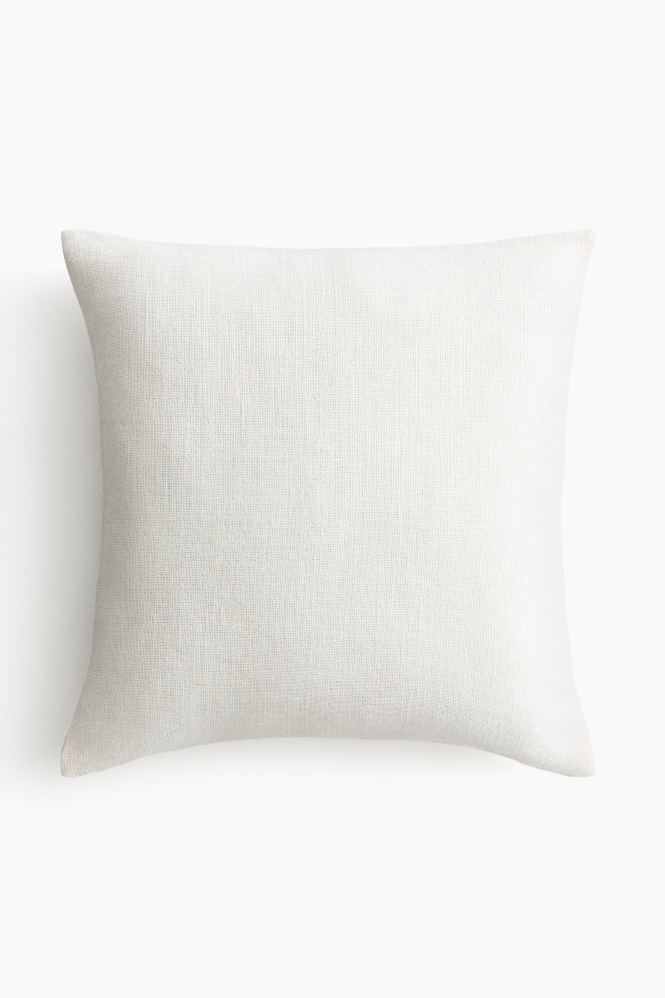 View larger image: The pillow is rectangular and displayed front-facing, showcasing a light cream hue with a distinct woven texture. Its edges are soft and gently rounded.