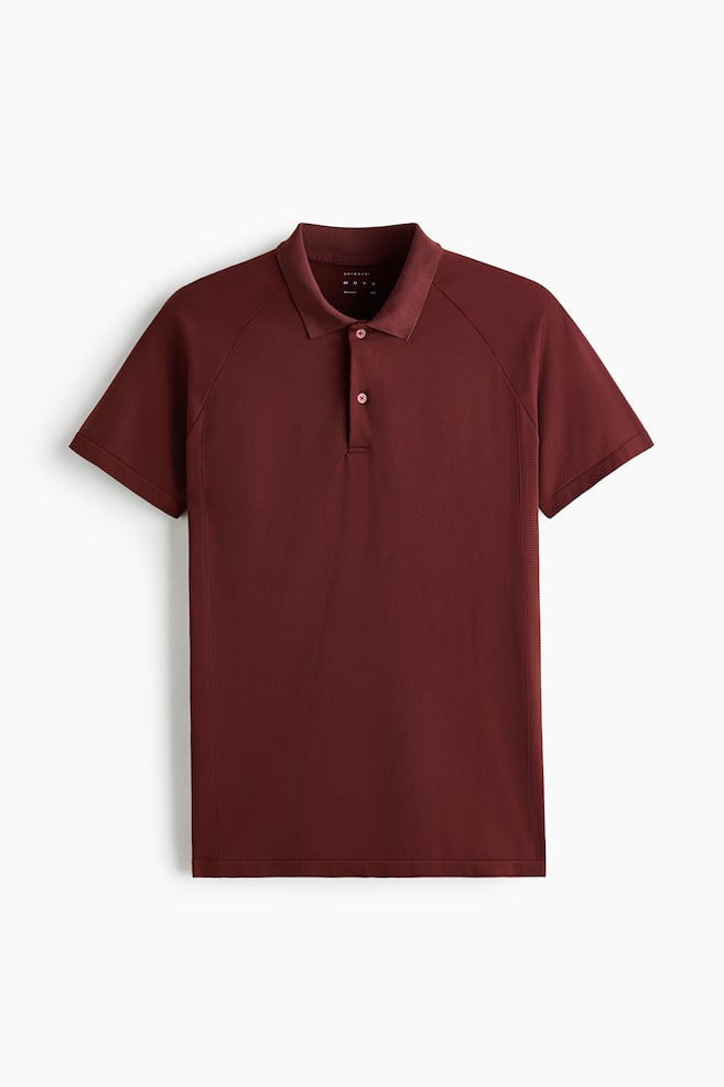 The Regular Fit Tennis T-shirt with DryMove? is showcased in a deep red hue, displayed front-facing. It features a pointed collar, a two-button placket, and short raglan sleeves, with subtle vertical ribbing detailing the sides of the shirt. - 1