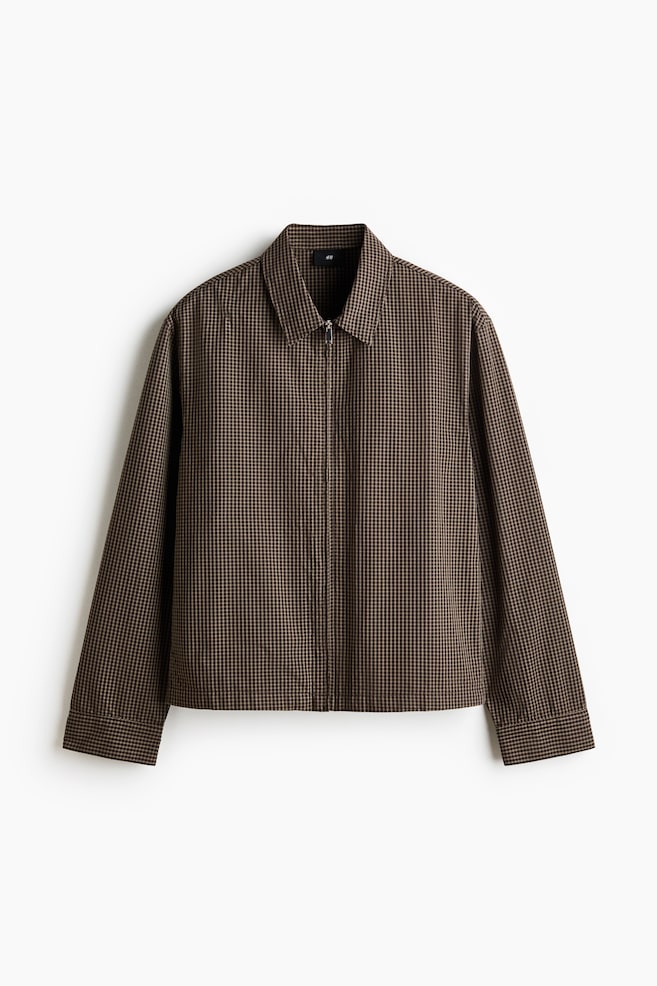 The jacket boasts a brown and beige micro check pattern, a pointed collar, a full-length zip fastening down the front, and long sleeves with single-button cuffs. - 1