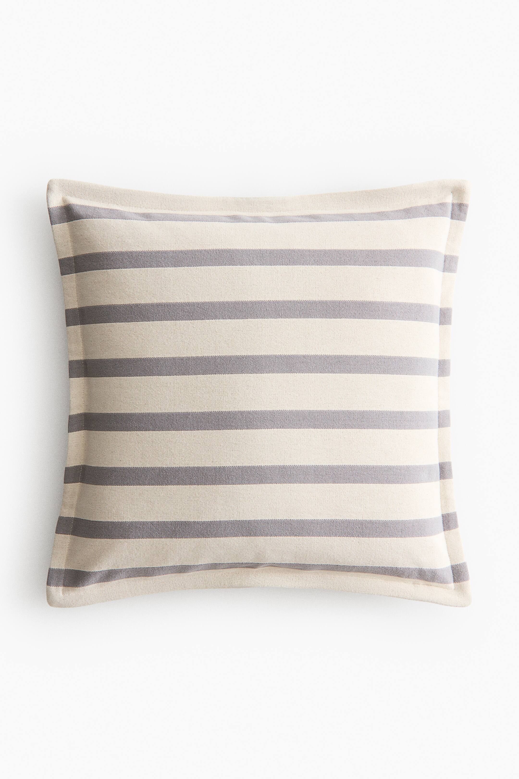 View larger image: A cushion cover is presented front-on, displaying a striped pattern. It is made from sturdy cotton canvas and features horizontal stripes in alternating light cream and medium grey.