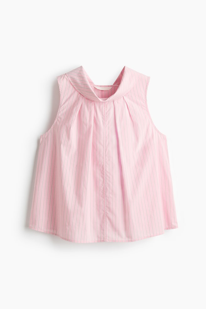 A sleeveless top in pink with thin gray vertical stripes is shown from the front. It features a wide, folded shawl collar, with pleats radiating down the front from the collar. - 1