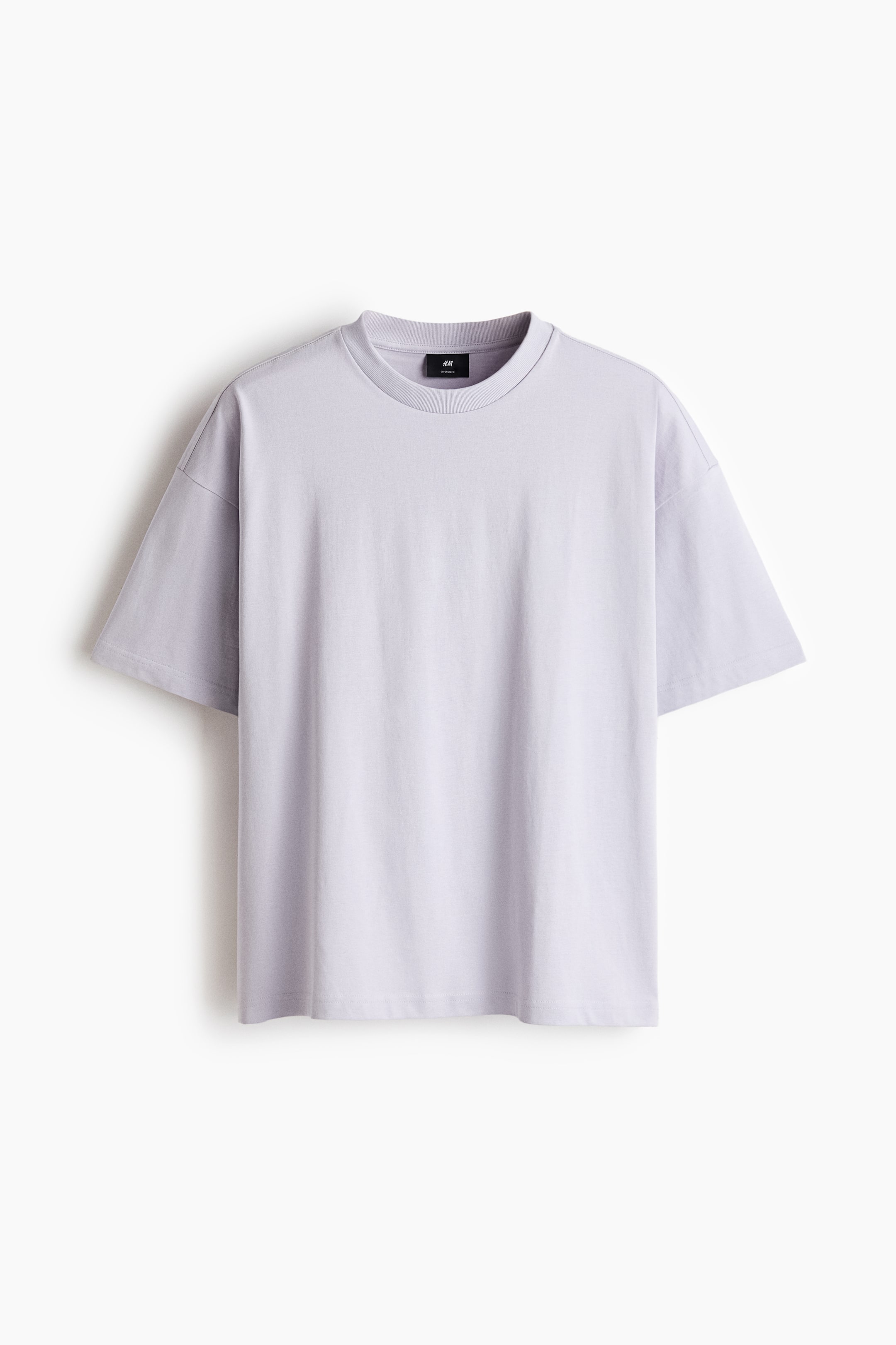 View larger image: A light purple boxy-style t-shirt in cotton jersey is shown facing front, featuring a round, ribbed neckline, dropped shoulders, and a straight-cut hem, showcasing an oversized fit for a baggy, extra-loose silhouette.