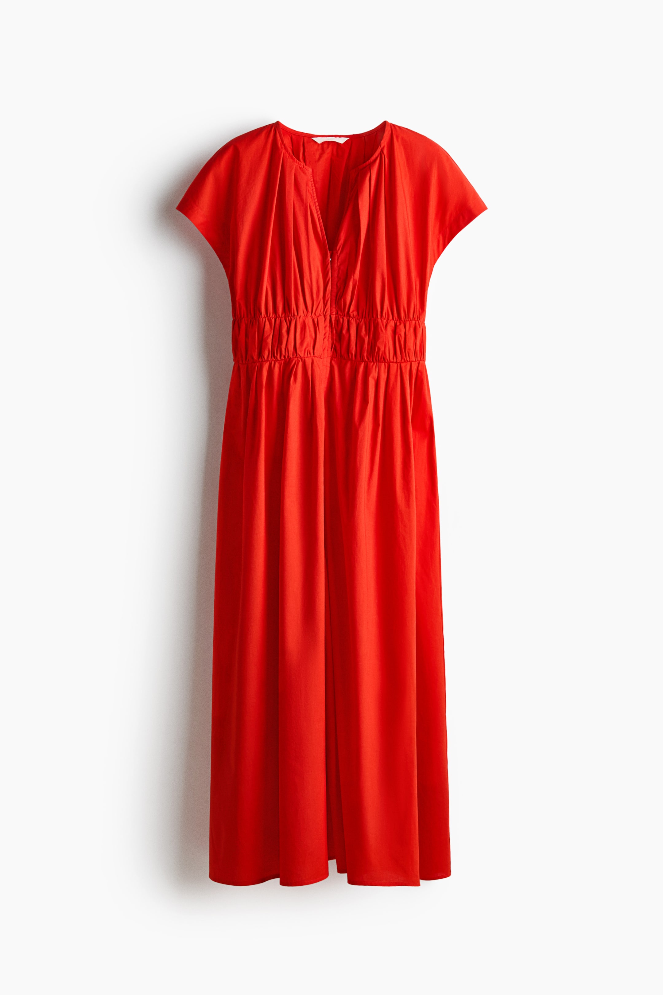 View larger image: A red dress is shown from the front, featuring a V-neckline and short cap sleeves. It presents gathers from the neckline down to a shirred, elasticated waist, with the flowing skirt falling to a midi length.