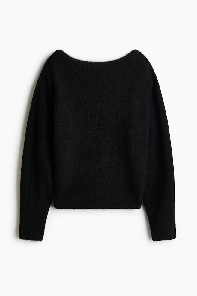 A black knit sweater, shown from the front, featuring a wide boat neckline, long sleeves with ribbed cuffs, and a straight hem. The garment has a soft, fuzzy texture and a relaxed-fit silhouette. - 1