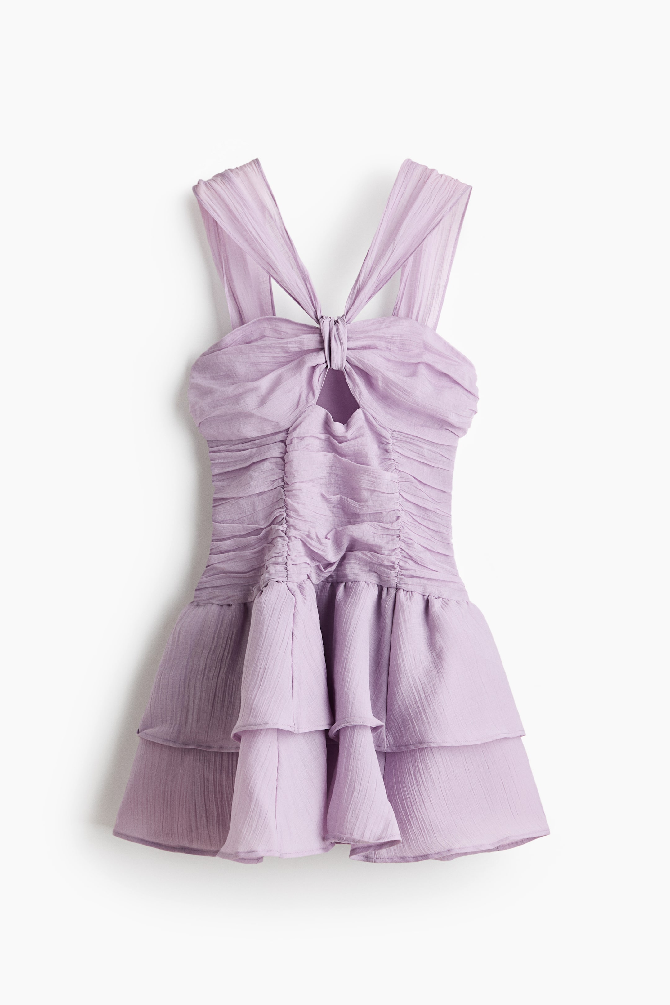 View larger image: A short light purple lyocell-blend dress is displaying its front view, featuring a sweetheart neckline with contoured cups and broad shoulder straps that converge at the center of the bust with a knot detail and a cut-out section. The ruched, fitted bodice transitions into a flared skirt that showcases flounced tiers, creating a voluminous silhouette.