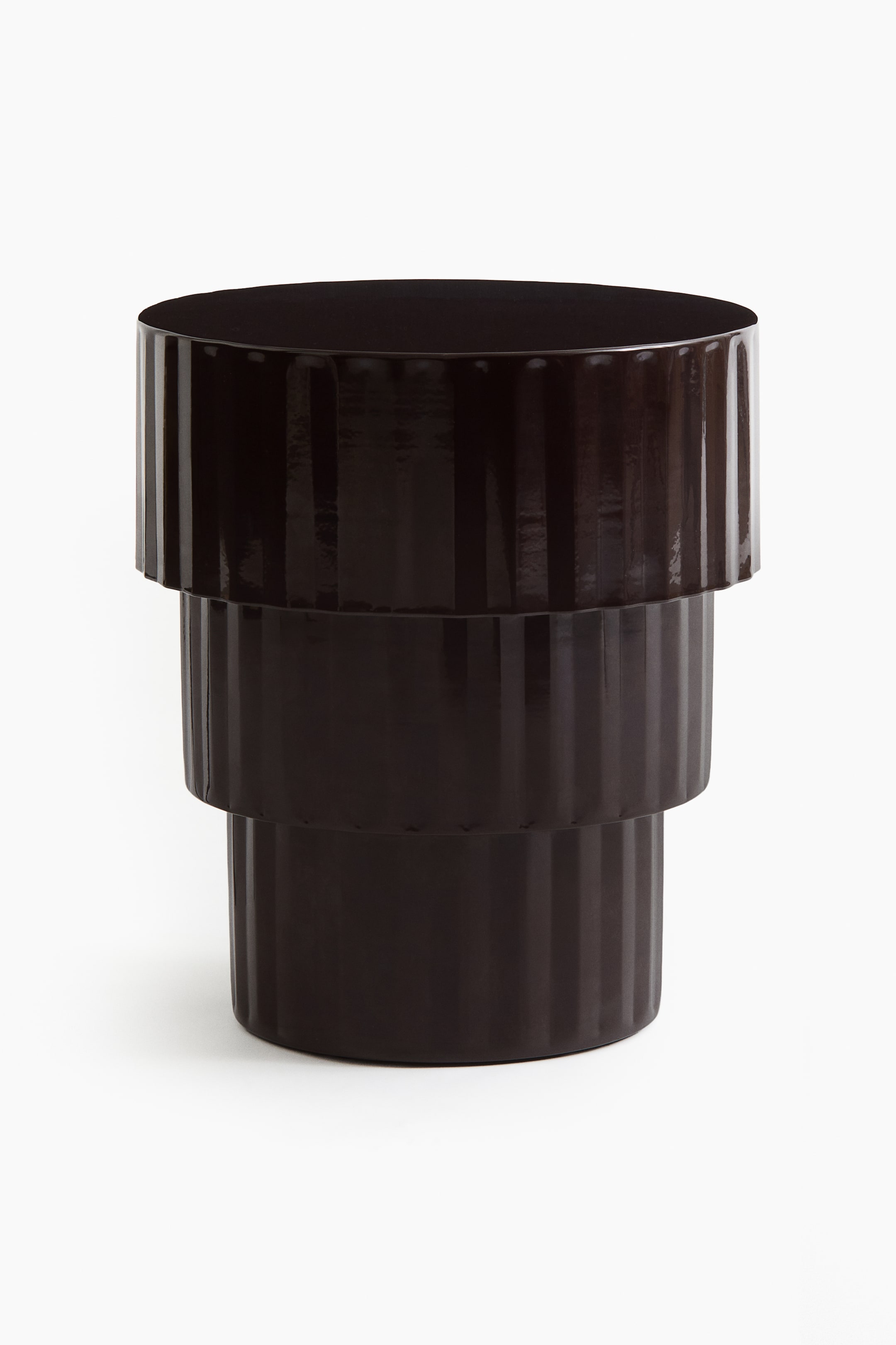 View larger image: A dark brown, glossy cylindrical object presents a tiered structure with three stacked sections. Each section features vertical fluting, and the overall form tapers slightly from top to bottom.