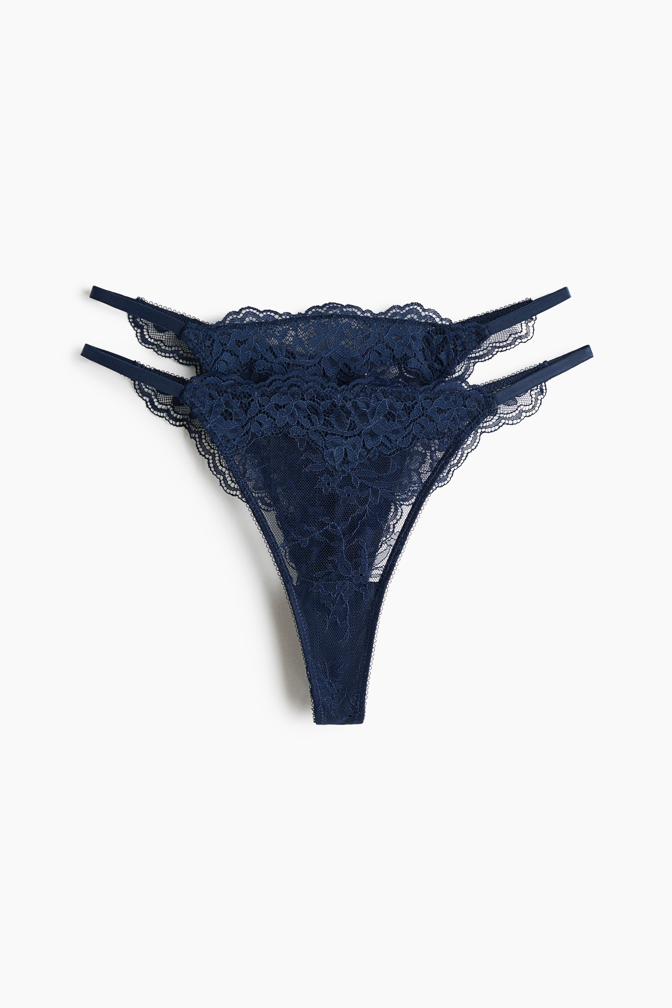 View larger image: Two navy blue lace thong briefs are displayed, facing front. They feature a low waist with a scalloped lace edge, narrow double elastic straps on the sides, and a lined gusset.