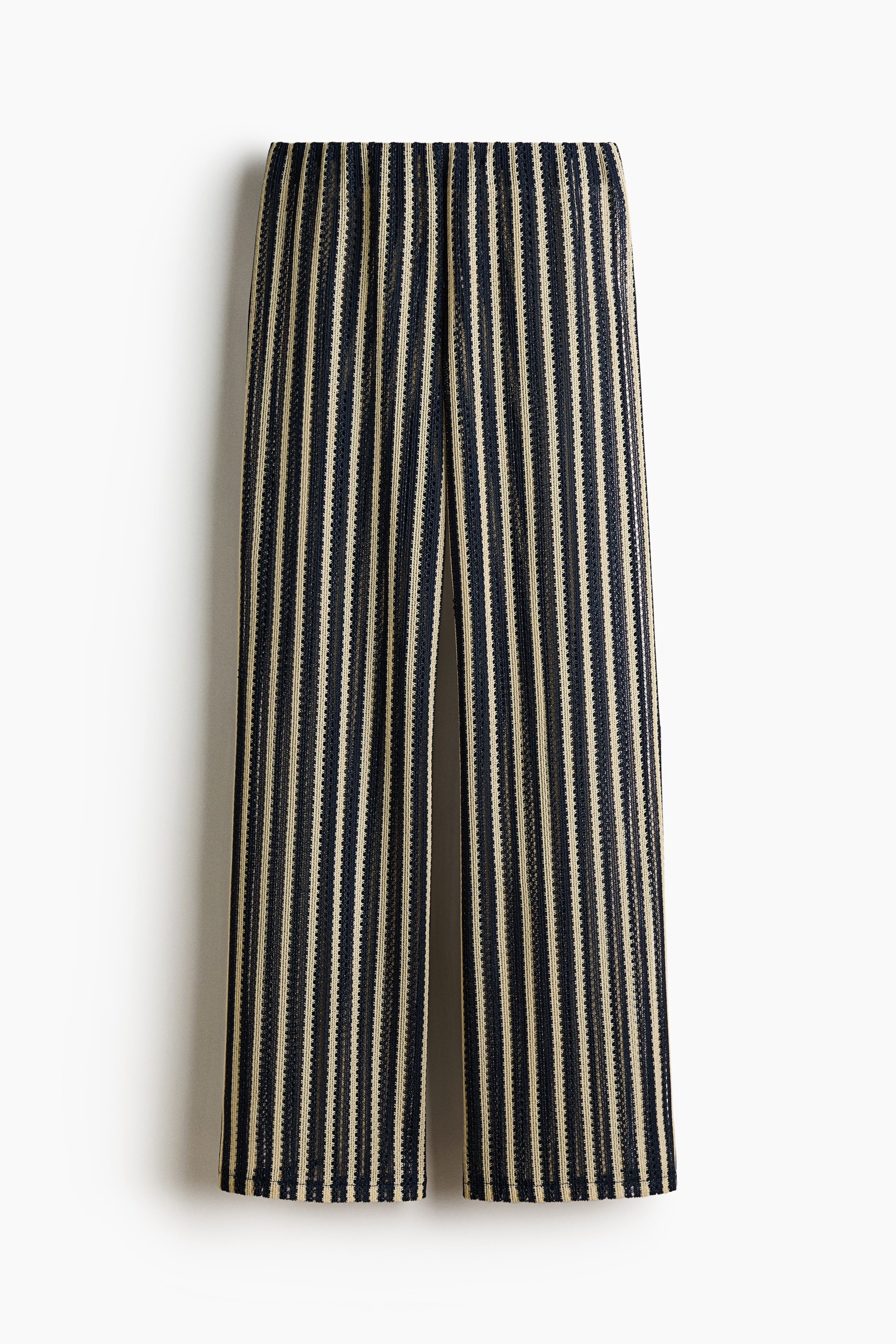 View larger image: The wide-leg pants feature black and beige vertical stripes in a textured knit fabric. They showcase an elastic waistband and hang flat, facing forward.