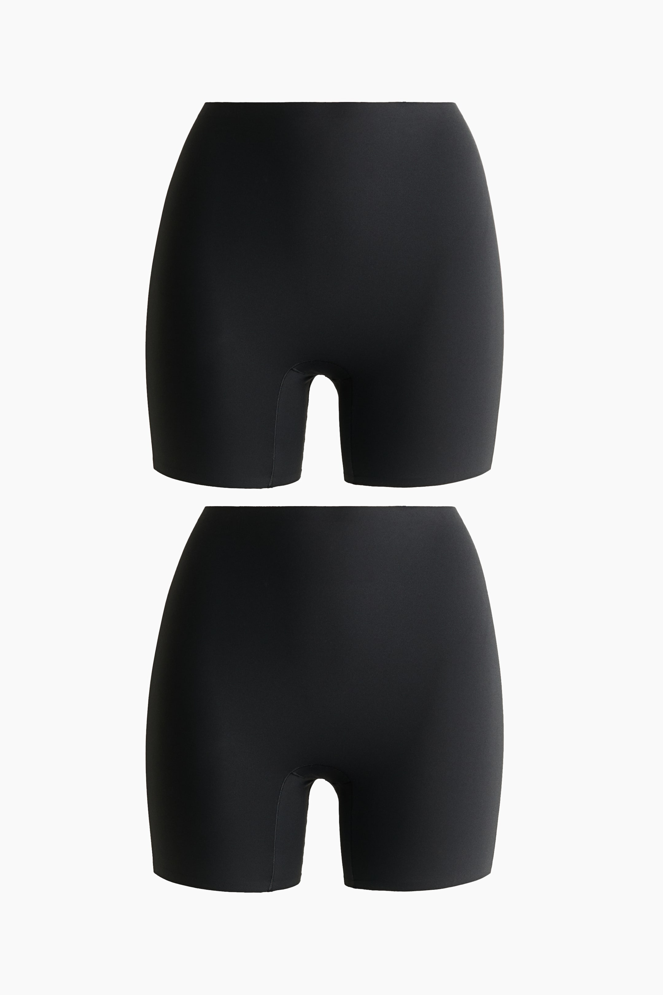 View larger image: Two pairs of black biker shorts, crafted from ultra-soft, stretch jersey with a high waist, are displayed from the front, showcasing a smooth, seamless finish.
