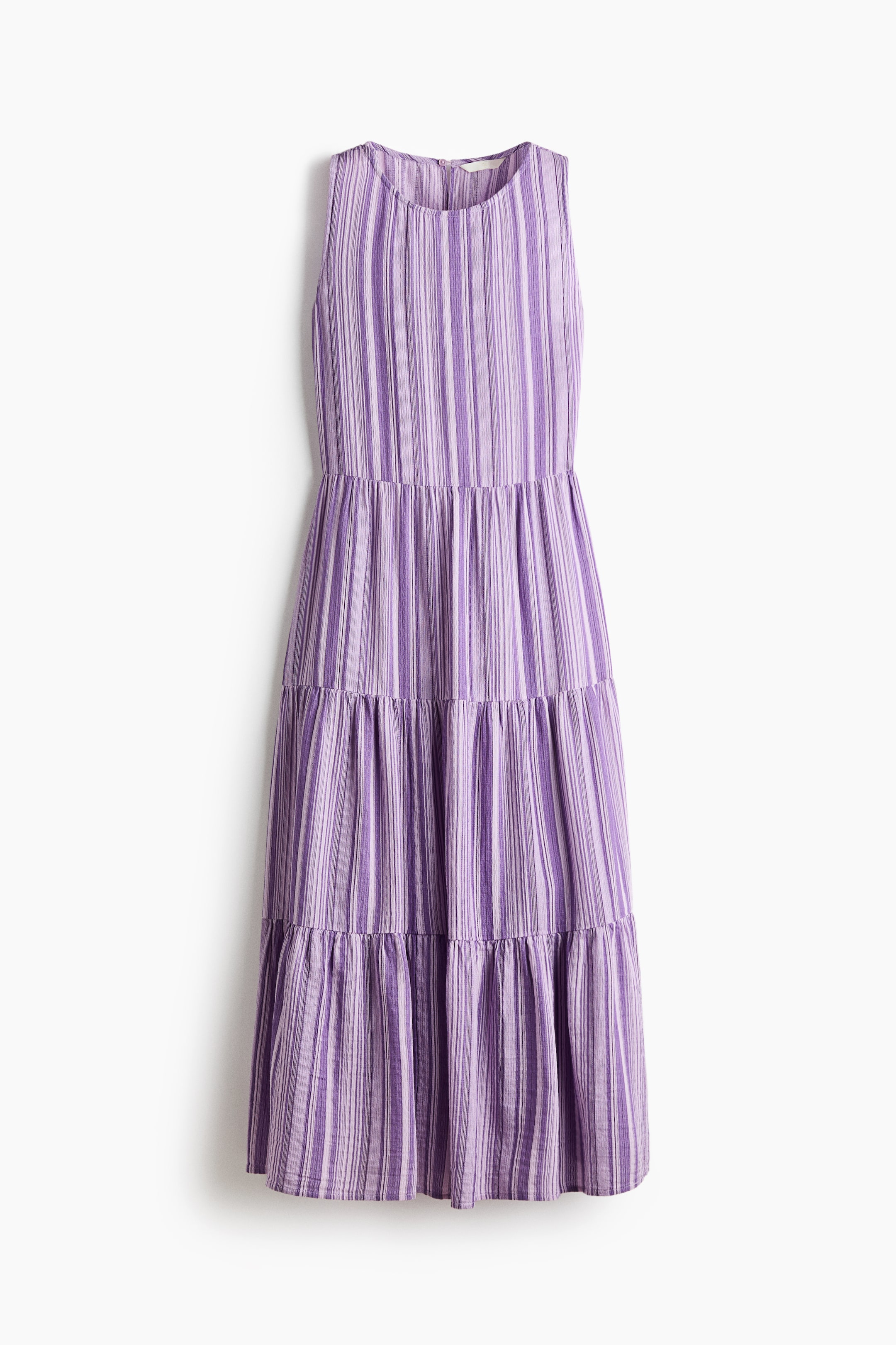 View larger image: A long, sleeveless dress is showcasing its front view, highlighting a textured cotton weave with vertical stripes in diverse shades of purple and white. It is crafted with a round neckline and a subtly A-line skirt that forms gathered tiers.