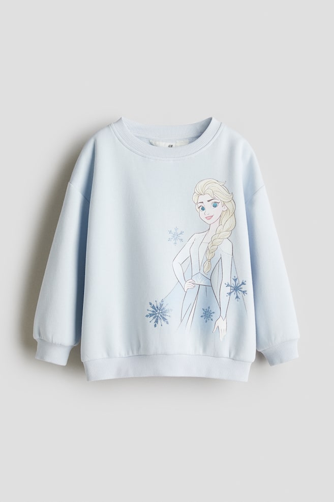 Bluza z nadrukiem - Jasnoniebieski/Kraina lodu/Jasnoniebieski/Kraina lodu/Biały/Kuromi/Jasnoniebieski/Cinnamoroll/Biały/Myszka Minnie/Jasnoniebieski/Lilo i Stitch/Jasnobeżowy/Lilo i Stitch/Biały/Hello Kitty/Różowy/Tweety/Fioletowy/Lilo i Stitch/Różowy/Hello Kitty/Kremowy/Hello Kitty/Kremowy/Hello Kitty/Żółty/Hello Kitty/Różowy/Świnka Peppa/Biały/Świnka Peppa/Jasnoniebieski/Hello Kitty/Różowy/Myszka Minnie/Szary melanż/Lilo i Stitch - 1