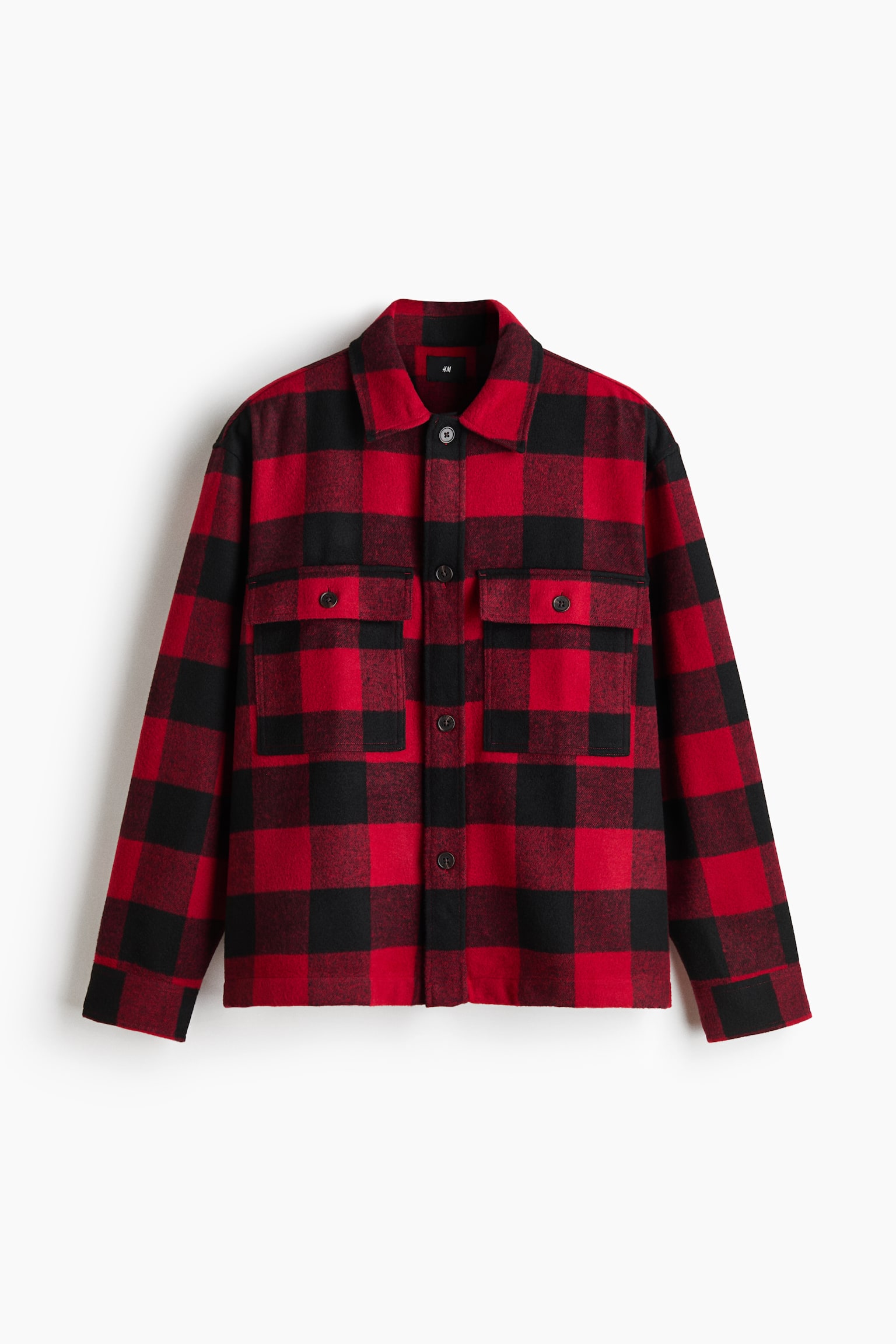 A red and black buffalo plaid shirt jacket is facing front, featuring a button-up closure with dark buttons, a classic point collar, and two chest patch pockets with buttoned flaps. The long-sleeved jacket is displaying a straight hem and buttoned cuffs.