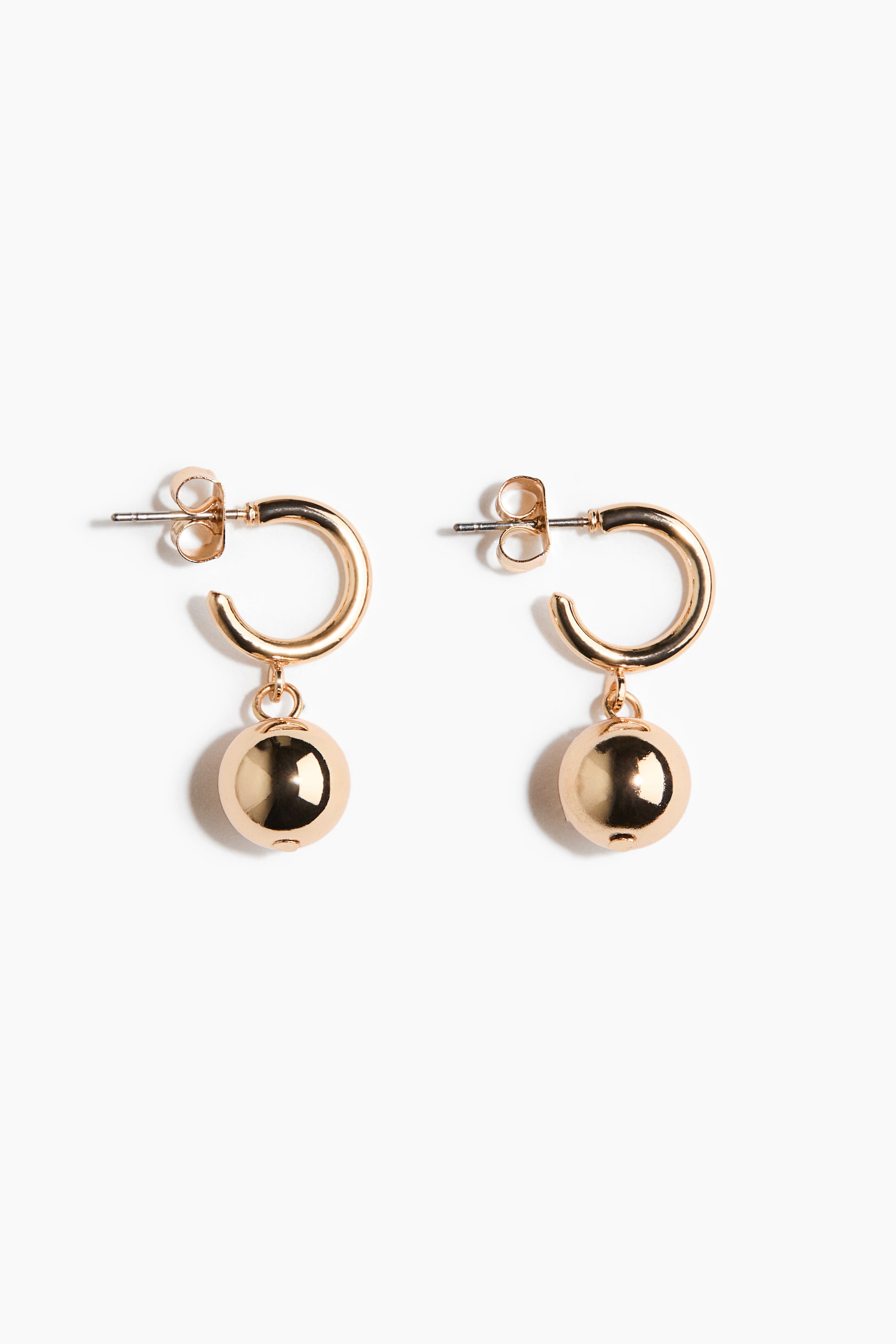 View larger image: Two gold-toned hoop earrings feature post-back closures, with a polished spherical ball dangling from each hoop.