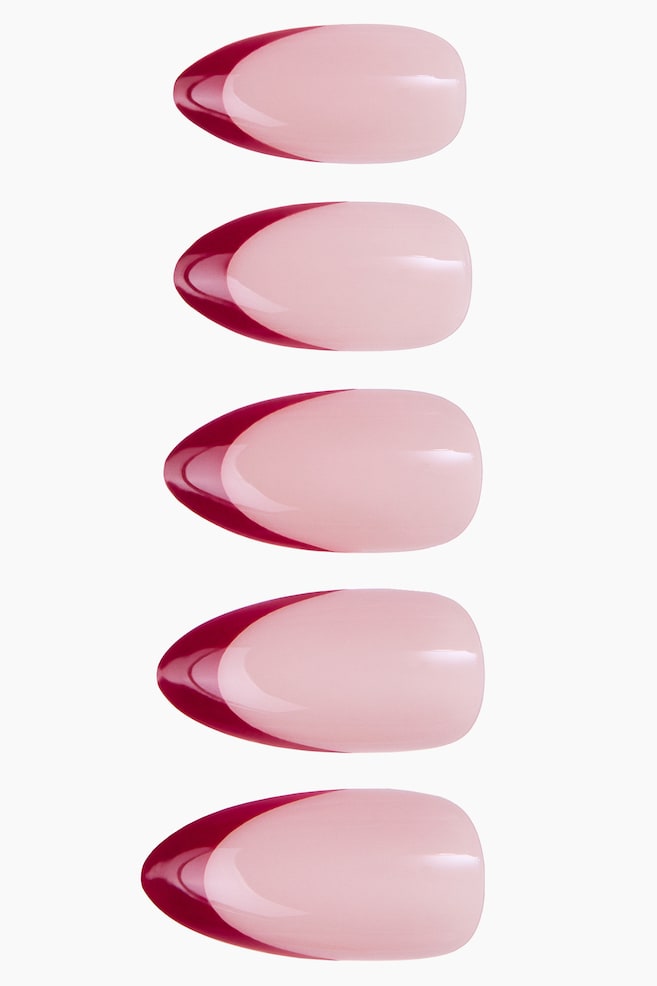 Five almond-shaped press-on nails are displayed in a vertical line from the front. The nails feature a glossy, light pink base with a deep burgundy French tip design curving along the pointed ends. - 1
