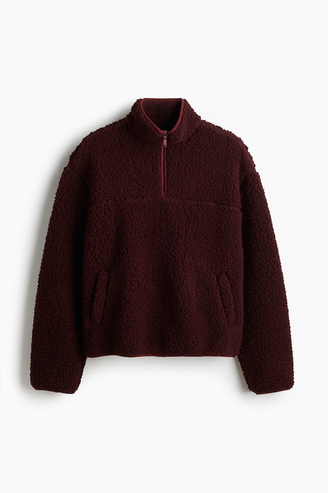 A maroon sherpa fleece half-zip pullover is shown from the front, featuring a stand-up collar and two angled slash pockets on the lower front. - 1