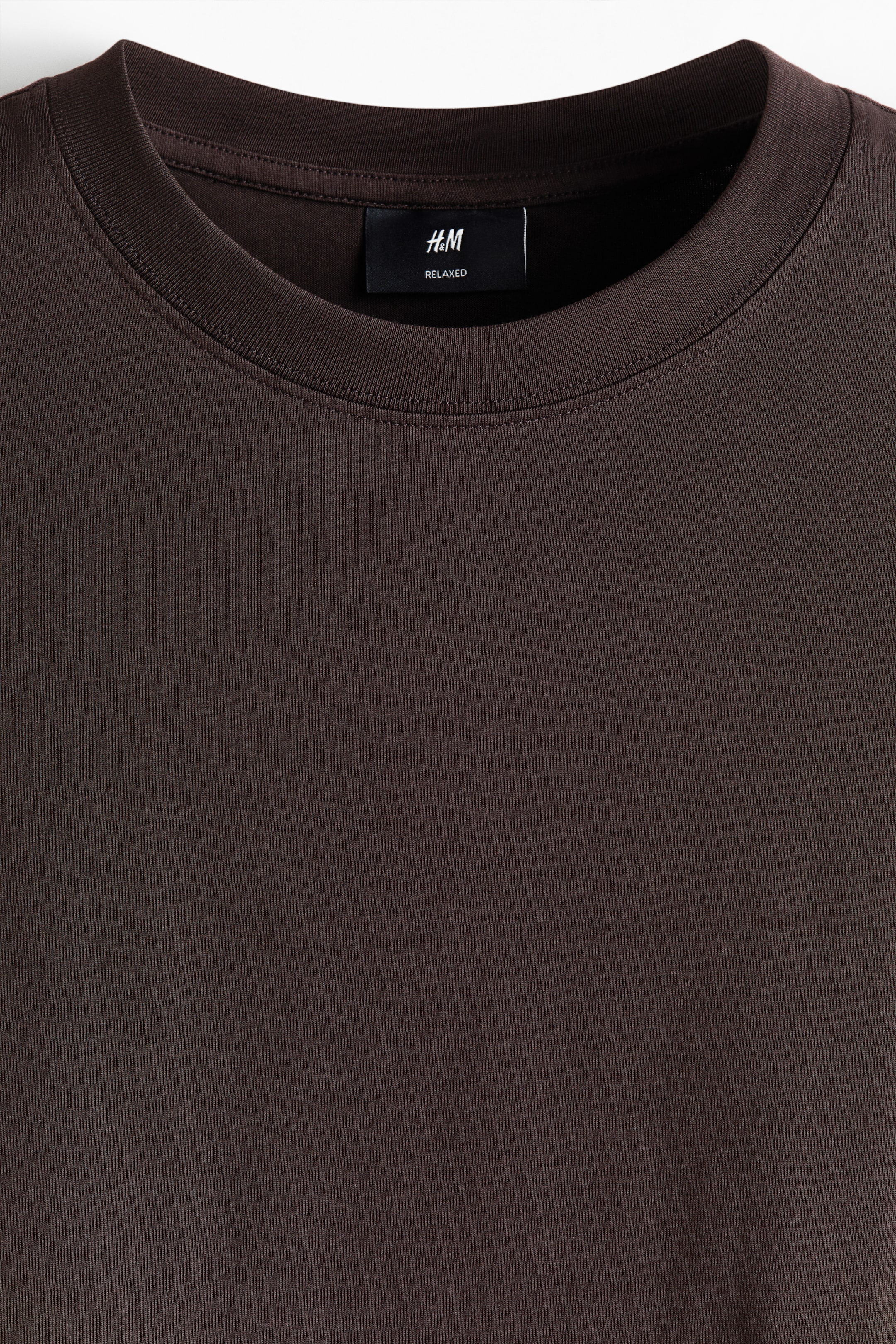 View larger image: A brown cotton jersey T-shirt featuring a round, rib-trimmed neckline, with an H&M "RELAXED" label on the inside of the back neckline.