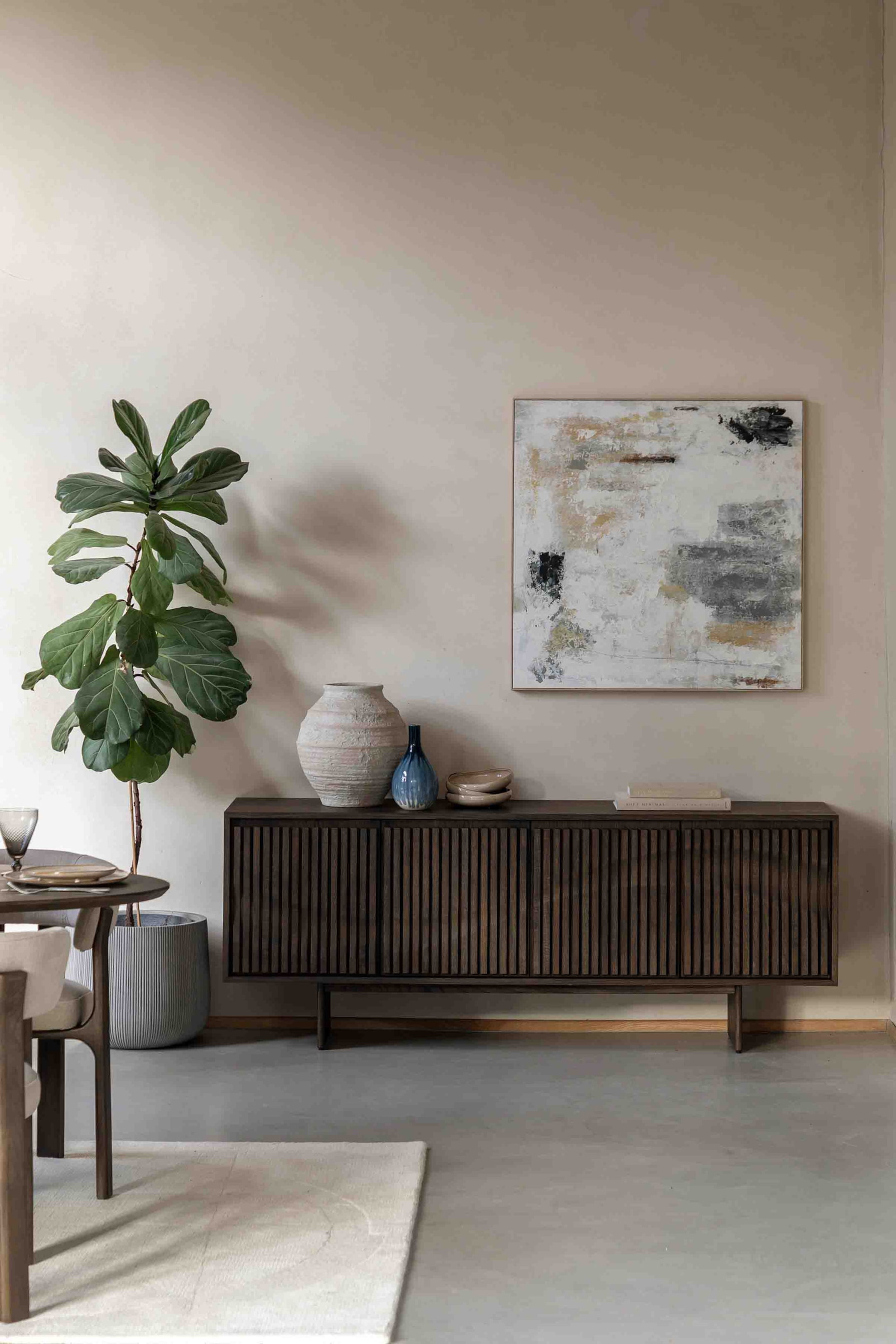 View larger image: A dark wooden sideboard presents its front, featuring multiple doors with vertical slatted detailing and standing on four tapered legs.