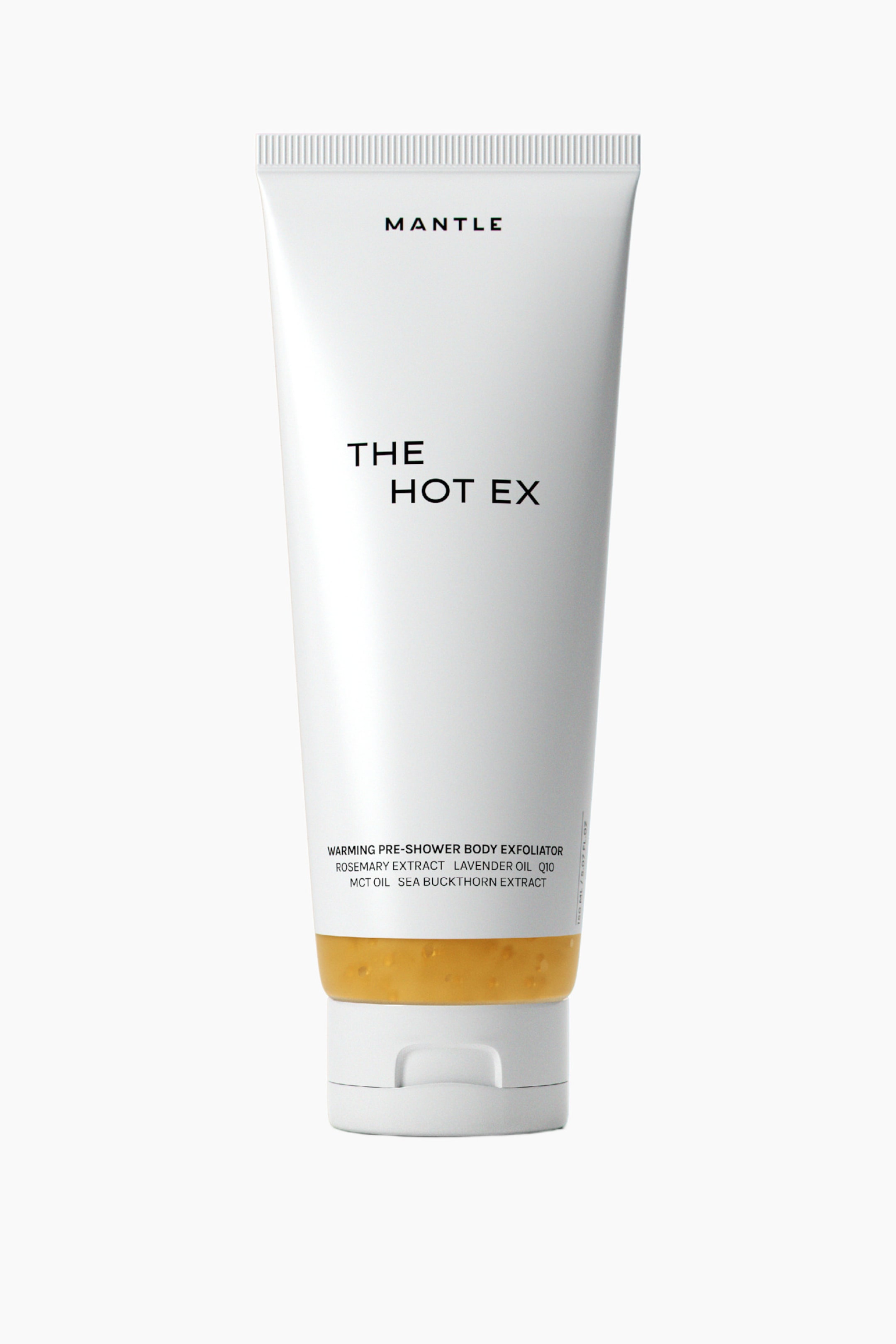 Visa större bild: En vit klämbar tub med kroppspeeling står upprätt och visar sin framsida. Den har "MANTLE" högst upp, "THE HOT EX" i tydlig text och "WARMING PRE-SHOWER BODY EXFOLIATOR" med ingredienser längst ner, där en orange produkt syns ovanför en vit snäpplock.