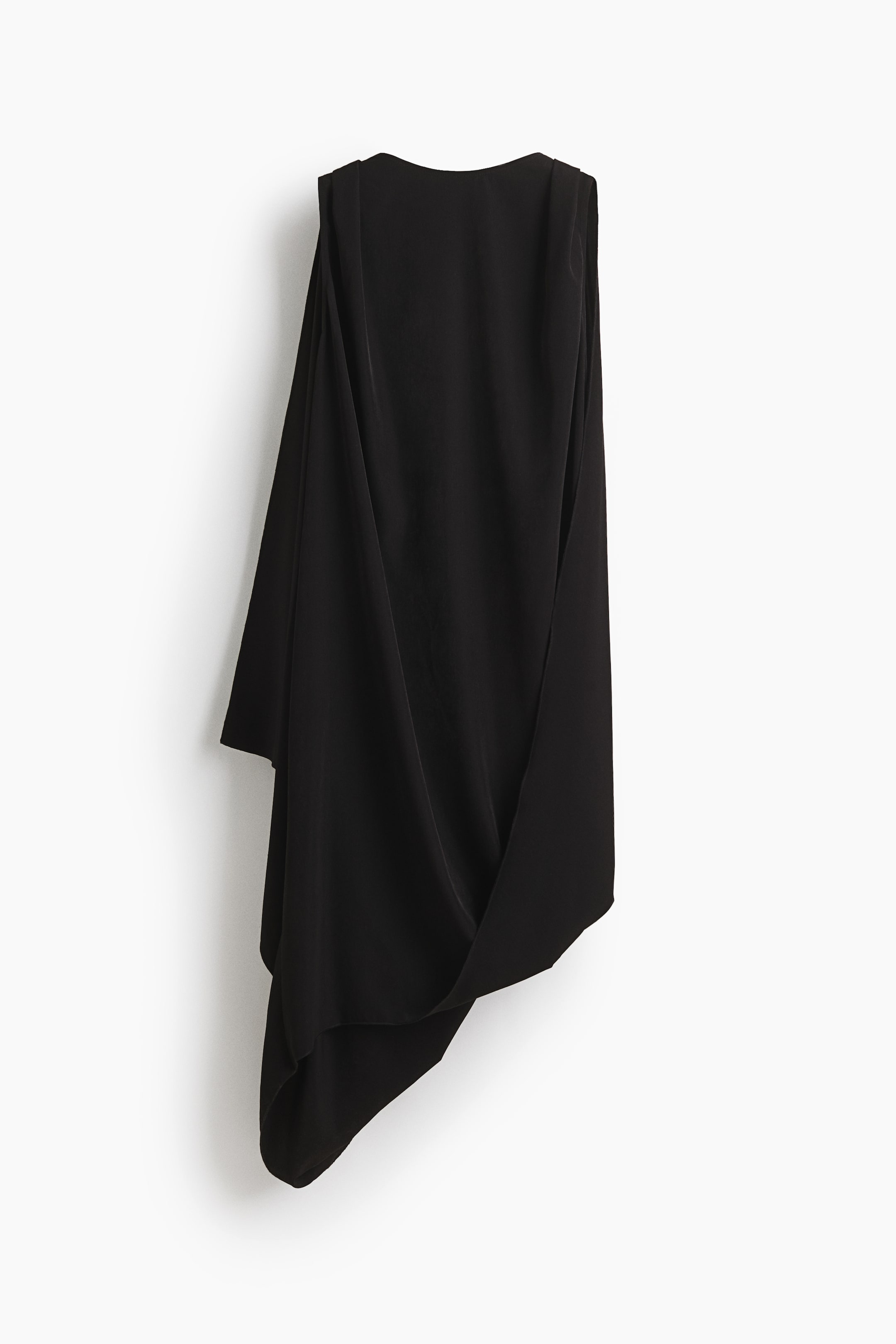 View larger image: A black sleeveless top showcasing a draped, asymmetrical silhouette, with a high rounded neckline and broad shoulders. The fabric elegantly flows to a pointed hemline on one side.