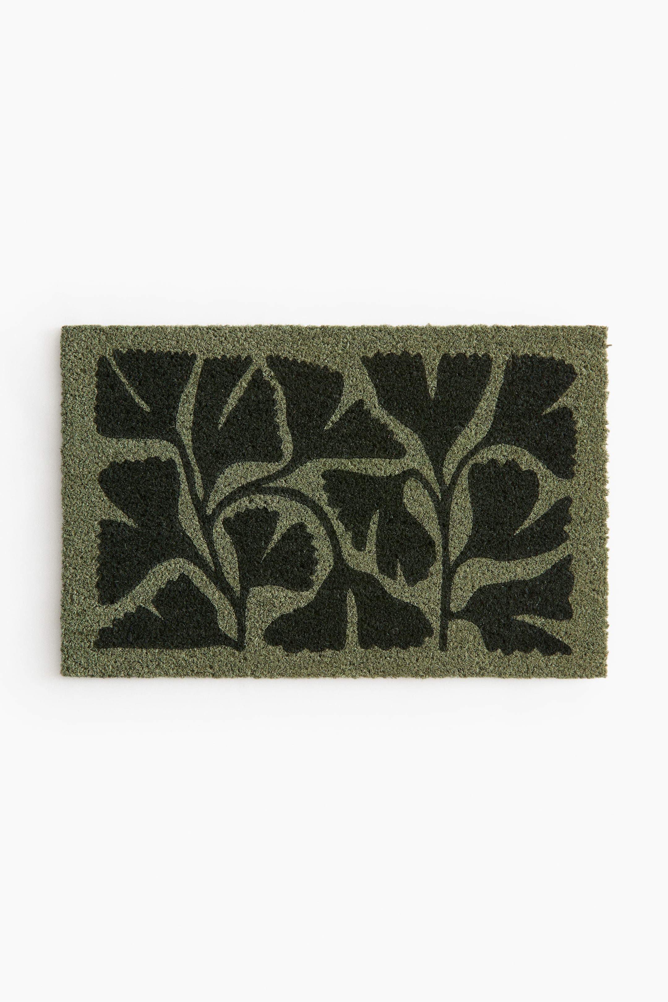 View larger image: A rectangular doormat features a bristly, coir-like texture with a dark green stylized ginkgo leaf pattern on a lighter olive green background.