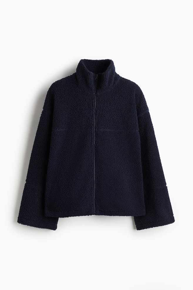A navy blue textured fleece jacket is shown from the front, featuring a high stand-up collar and a full-zip closure. It has long, relaxed sleeves and subtle horizontal panel seams on the front. - 1