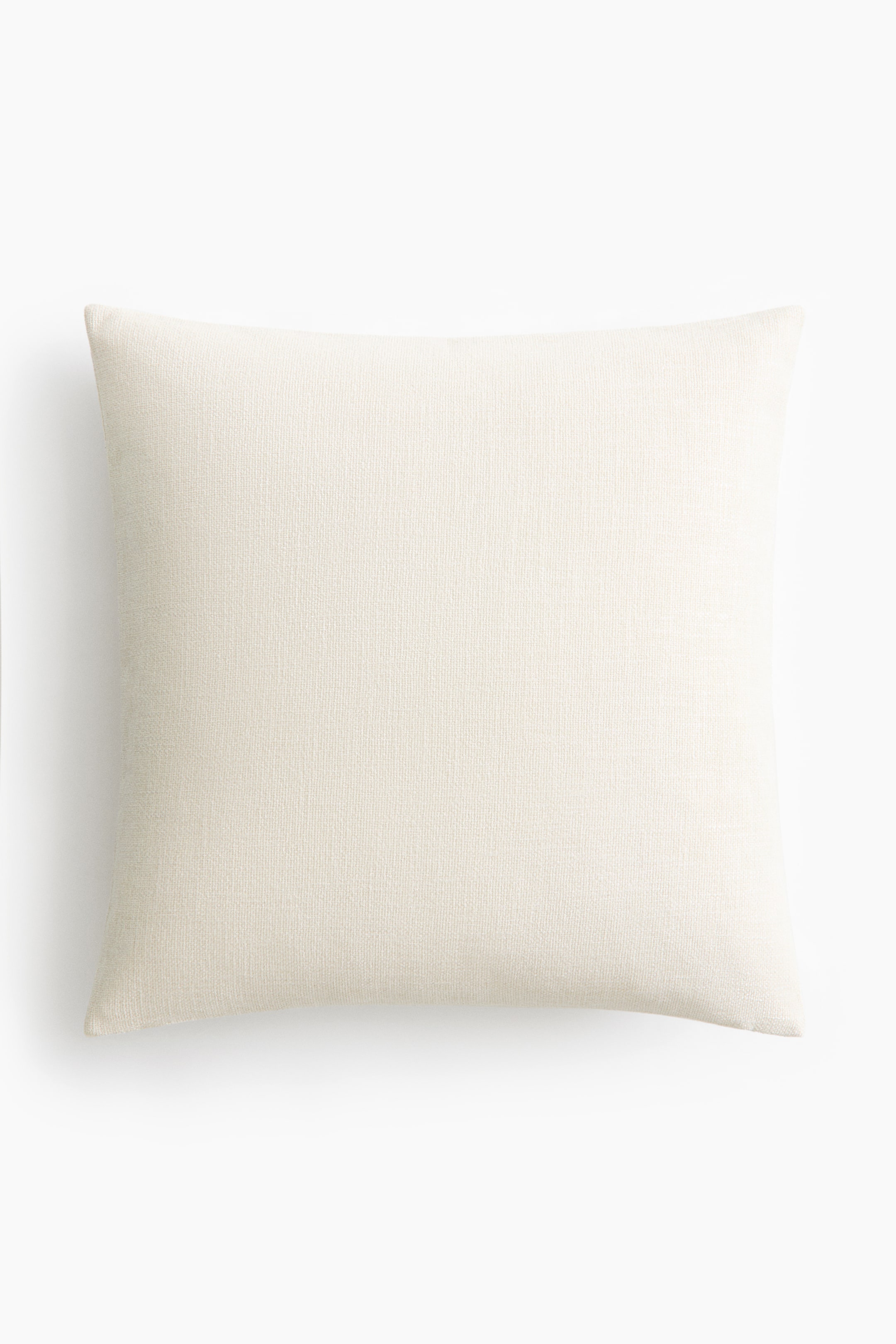 View larger image: A rectangular pillow is positioned front-facing, showcasing a light cream hue and a woven texture.