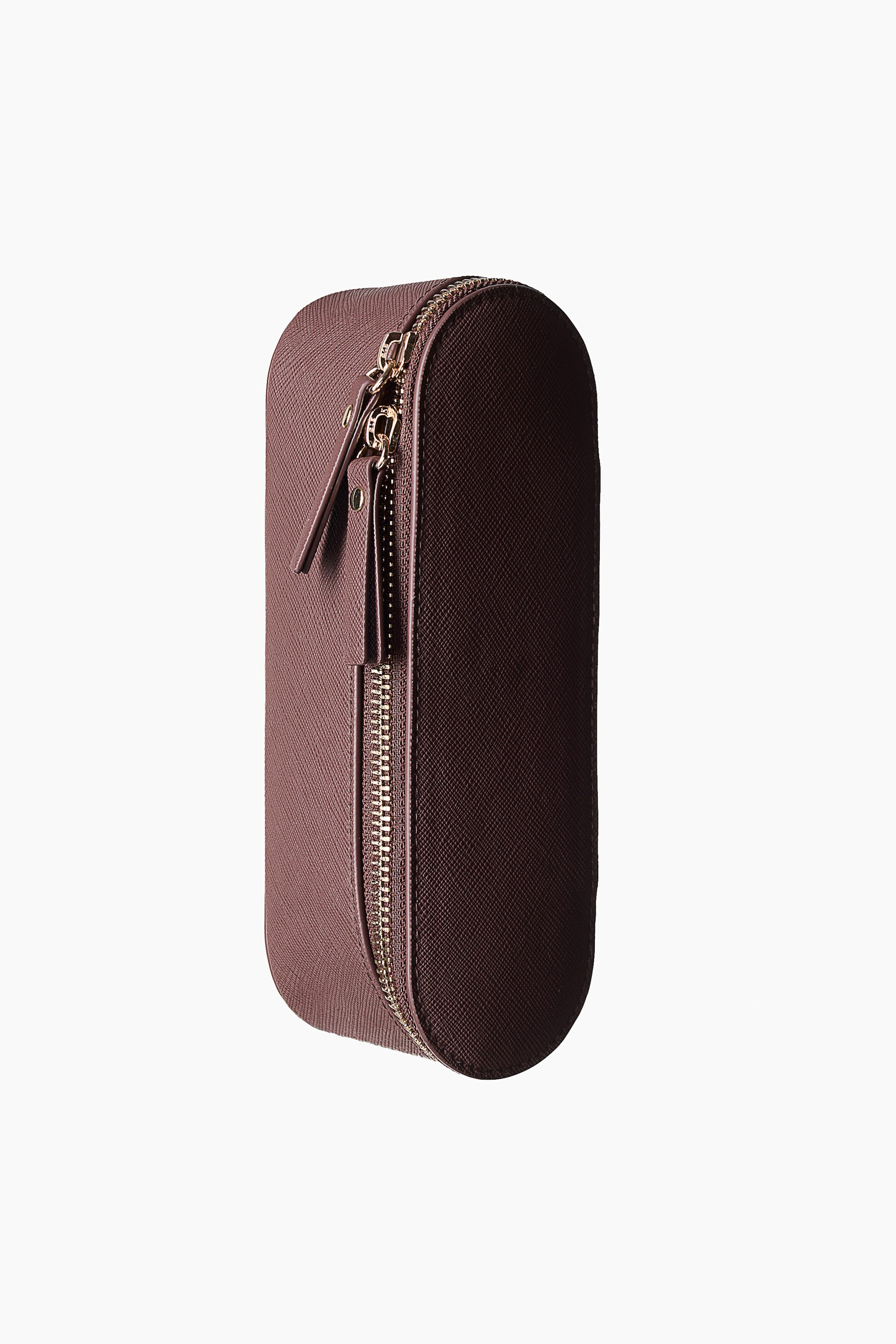 View larger image: A plum-coloured, elongated case with a fine crossgrain texture stands upright, angled slightly to the right, featuring a gold-toned zip with two matching pulls running along the full length of one side and following the case's rounded ends.