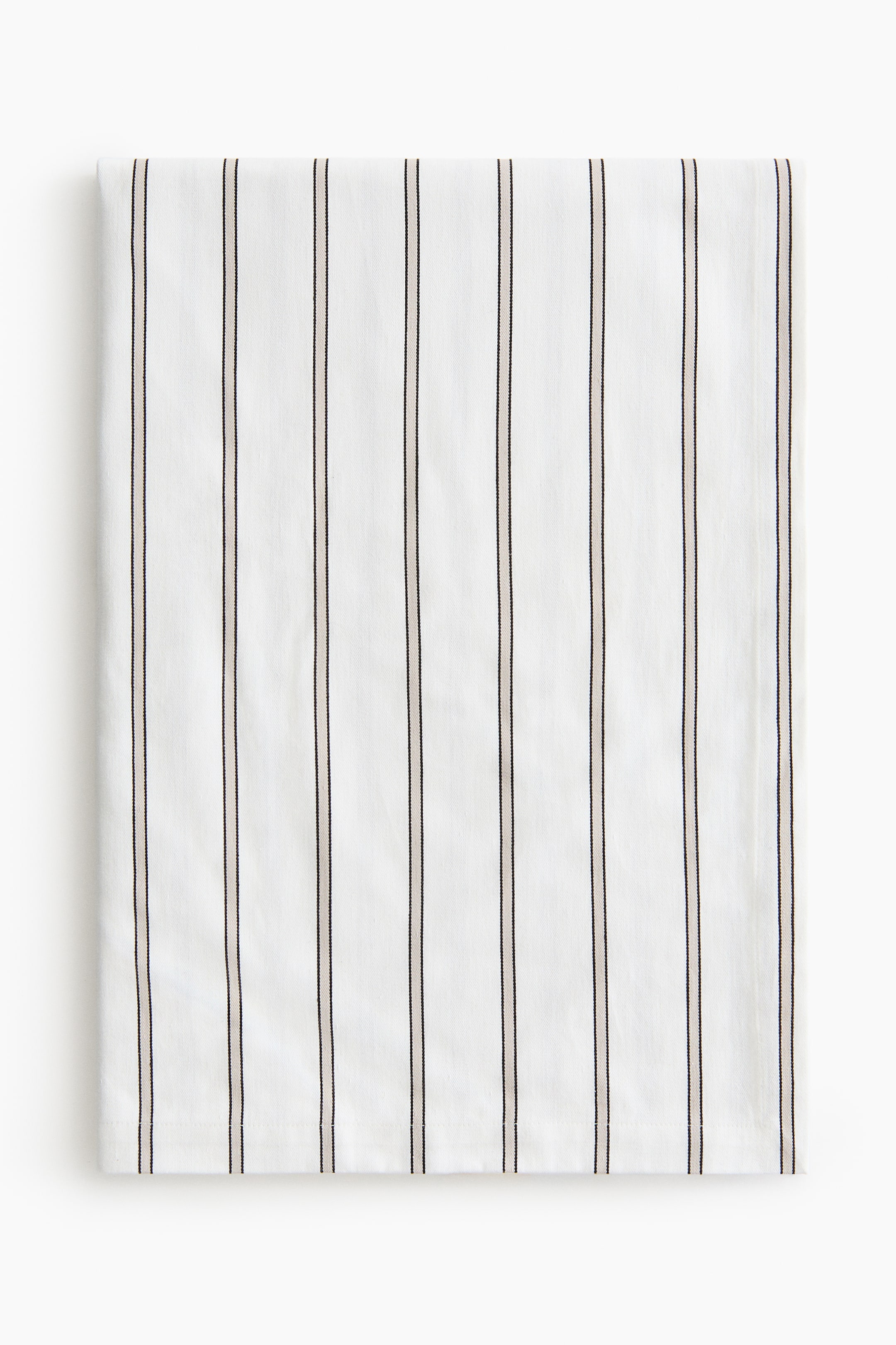 View larger image: A white textile is laid flat, displaying vertical pinstripes, with each pinstripe formed by a thin pinkish-beige line centred between two thin black lines.