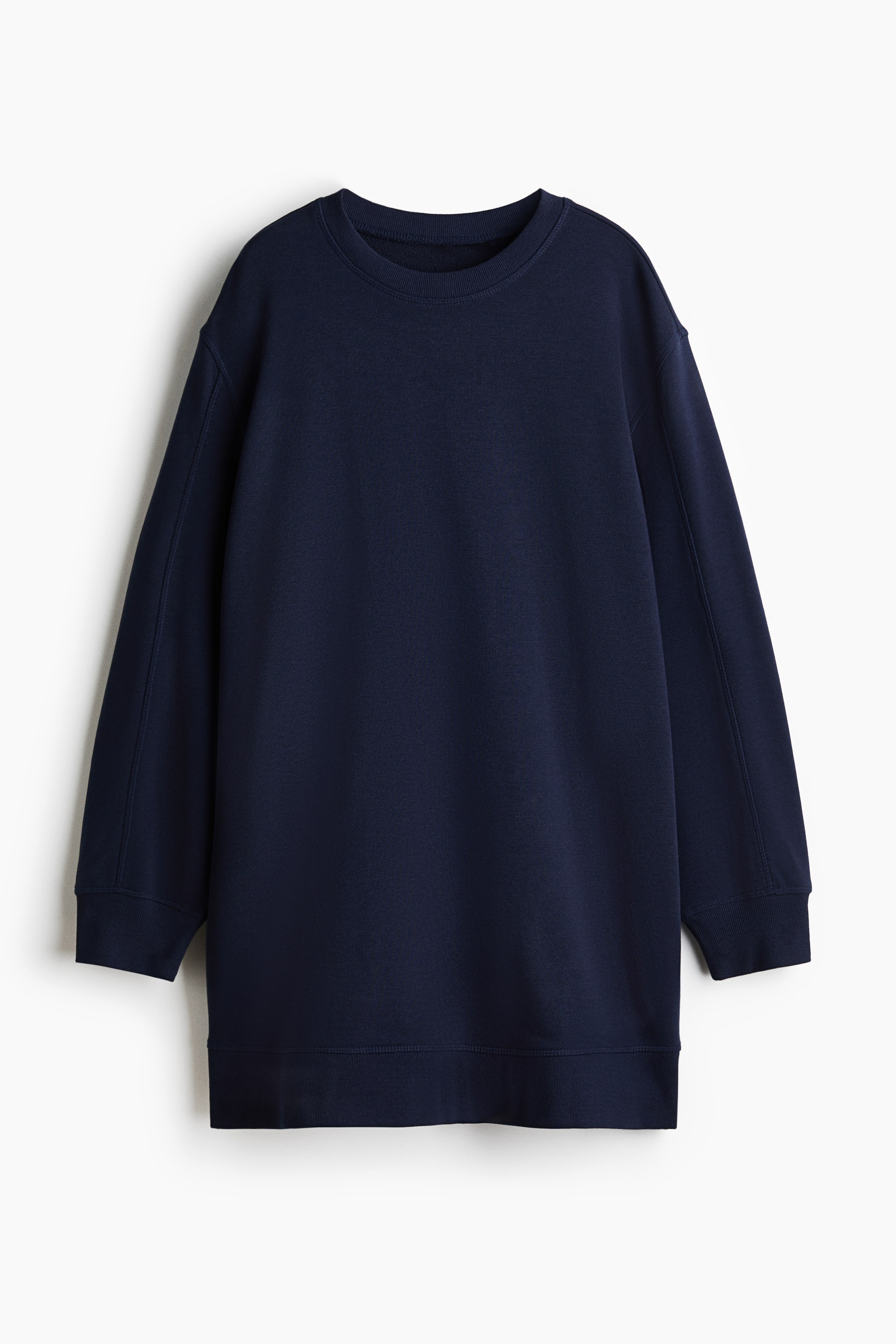 View larger image: A dark blue short dress in sweatshirt fabric is shown from the front, featuring a loose fit with a round, rib-trimmed neckline, dropped shoulders and long sleeves with ribbed cuffs. A ribbed hem finishes the bottom of the dress, and visible flatlock seams run along the sleeves and sides.