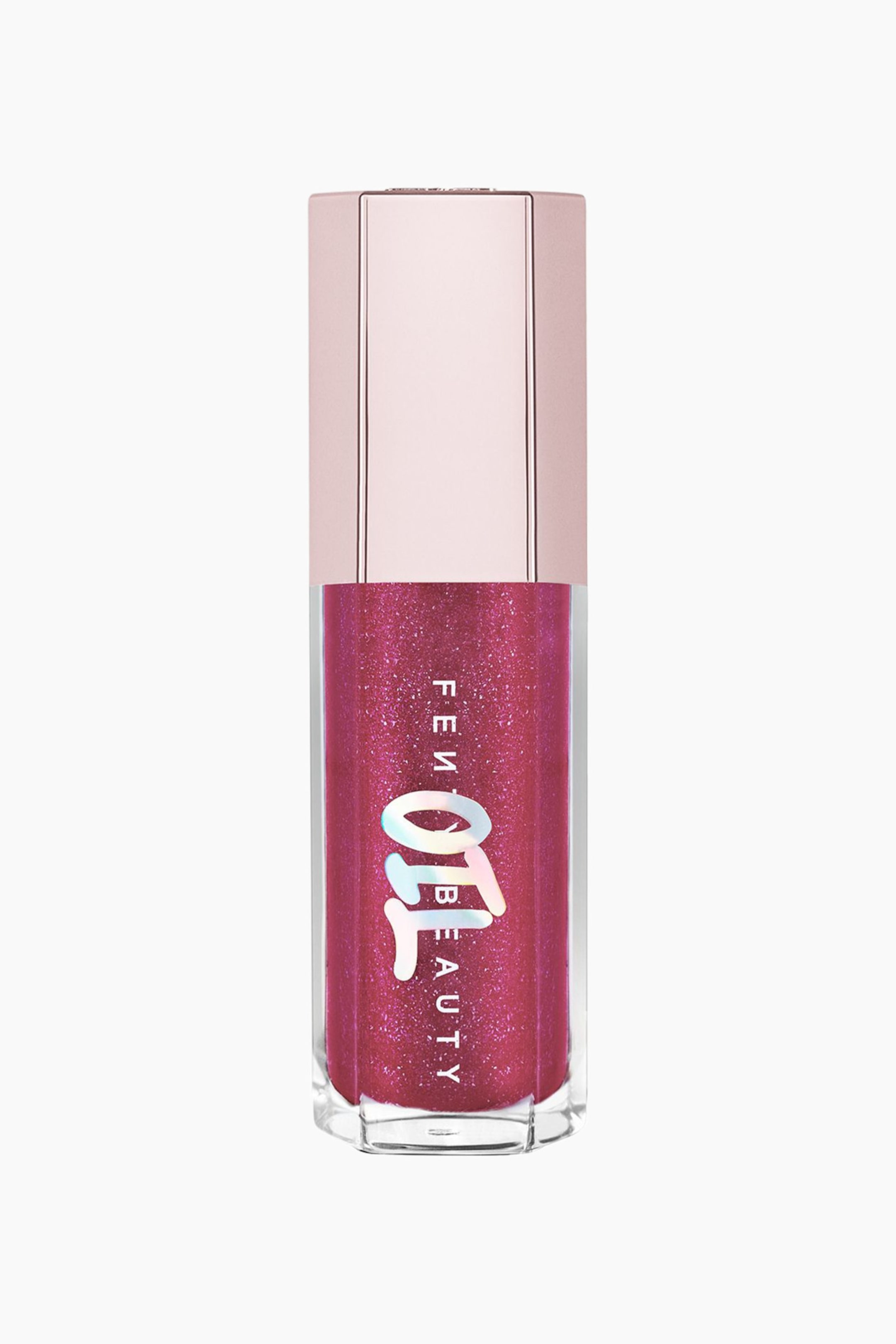 Visa större bild: Gloss Bomb Oil Luminizing Lip Oil 'n Gloss står upprätt och visar upp en sexkantig genomskinlig behållare fylld med en skimrande, glitterig bärrosa vätska. Den har en metallisk, ljus roséguldfärgad sexkantig kork och vertikal brandingtext på framsidan, överlagrad med en holografisk "OIL"-design.