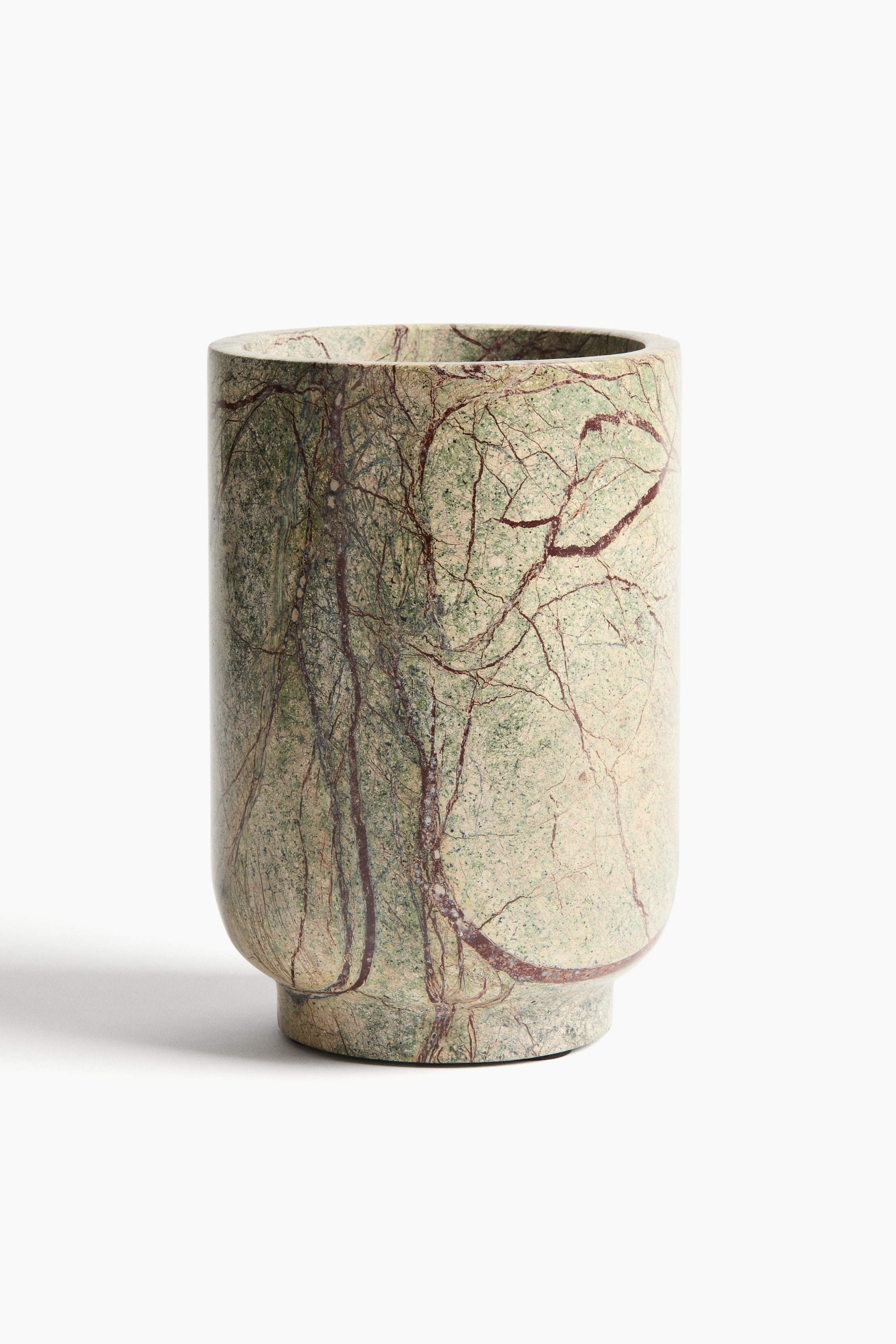 View larger image: A marble cooler is placed facing the front, showcasing a cylindrical shape that gently widens towards the base. Its surface features a light green and cream background with prominent dark reddish-brown veining.