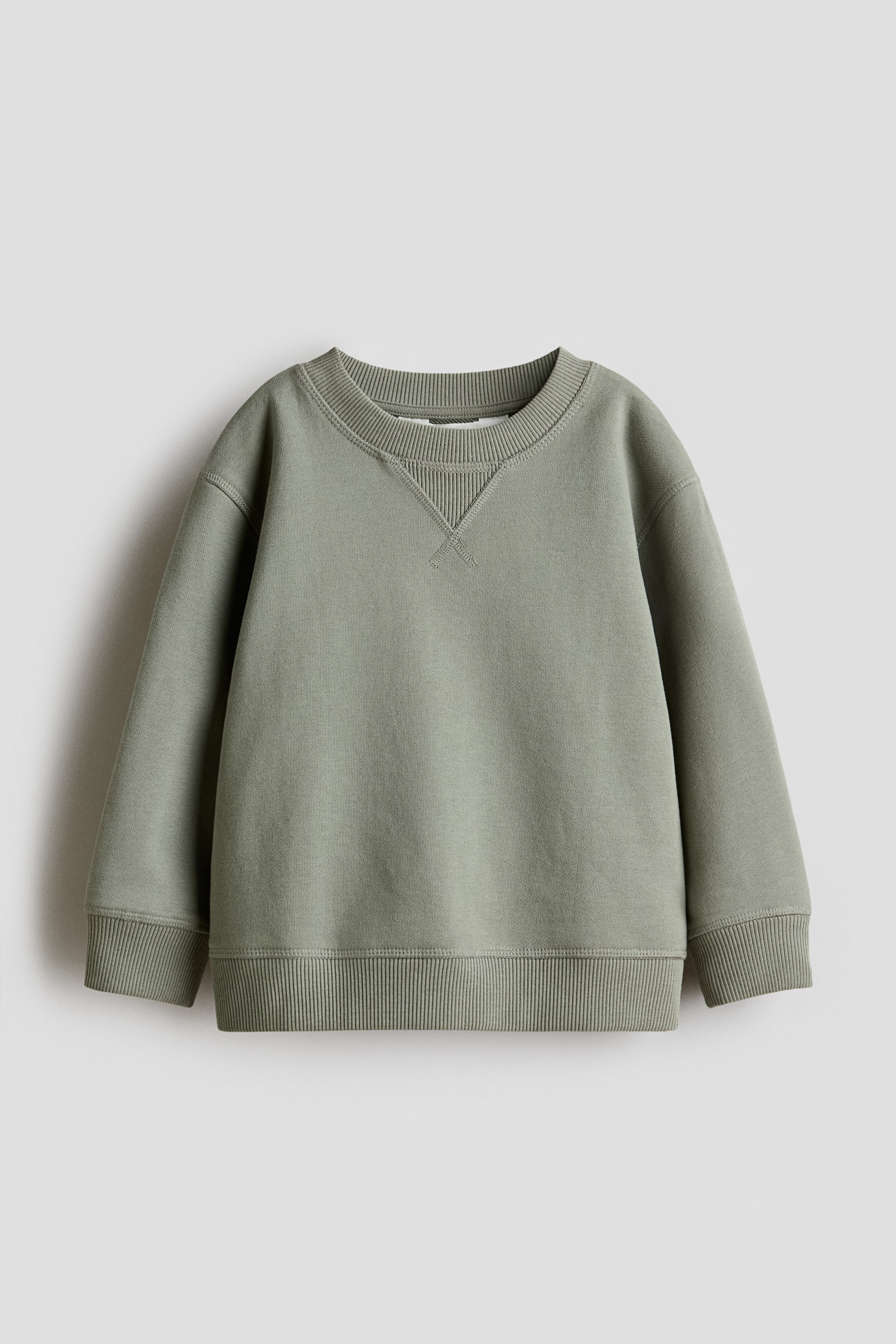 View larger image: A light green crew-neck sweatshirt is displaying its front, featuring a ribbed neckline with a V-stitch detail, dropped shoulders, and ribbed cuffs and hem.