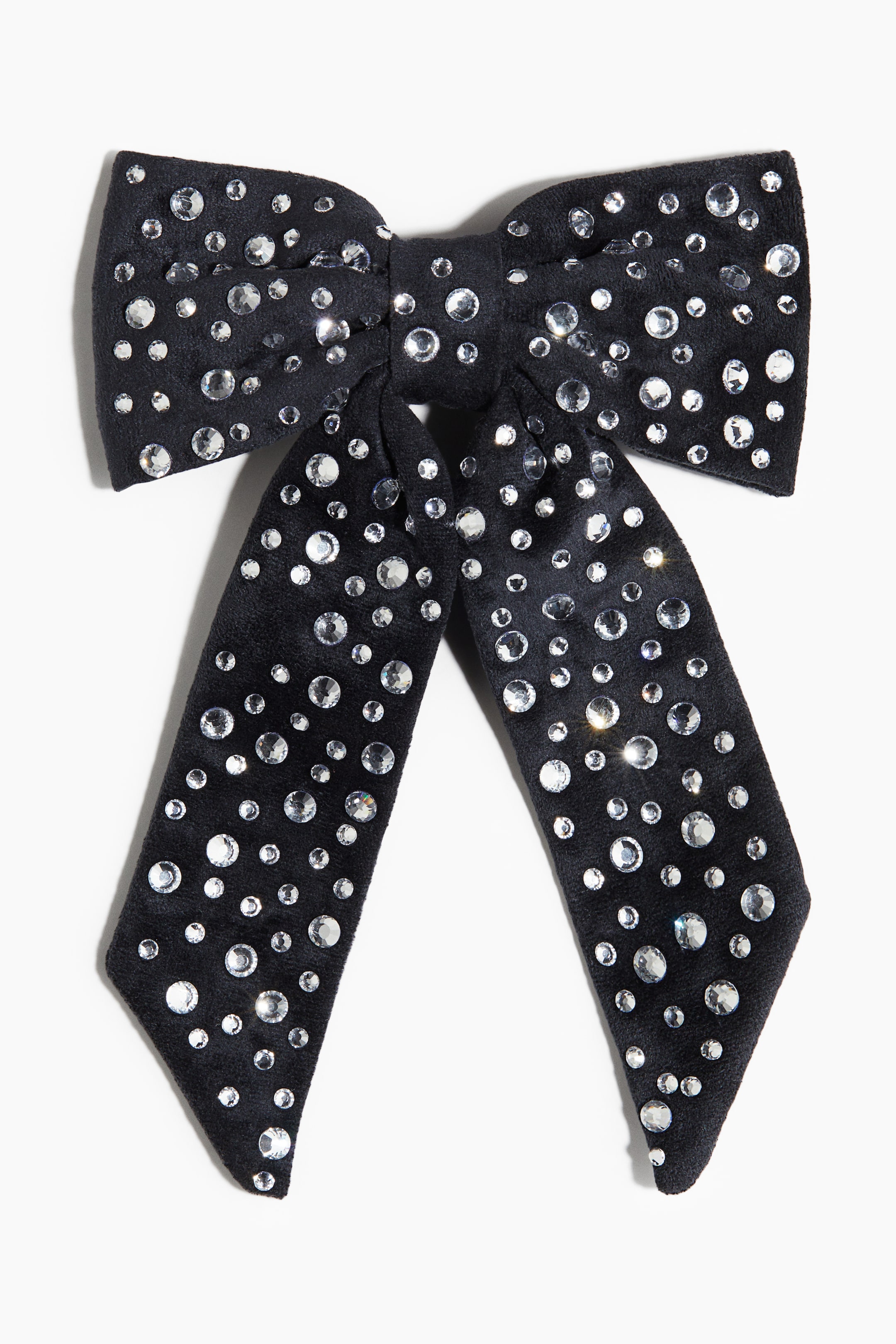 View larger image: A black velvet bow, seen from the front, is covered in clear, round rhinestones of various sizes, forming two loops at the top and two long, angled tails extending downwards.