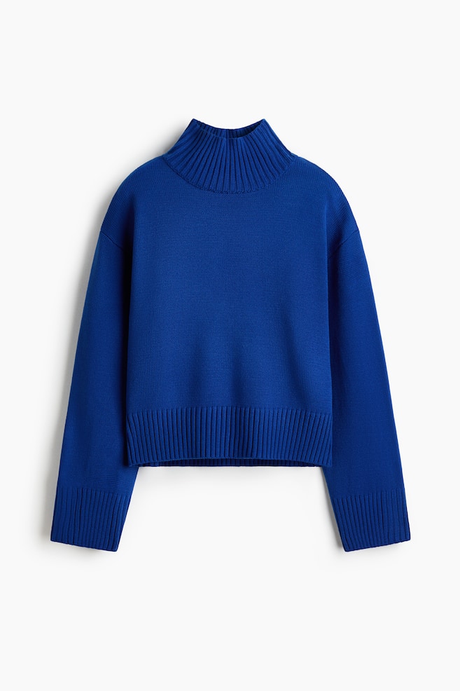 A front-facing royal blue knitted jumper is displaying a ribbed roll neck, dropped shoulders, and long sleeves. The jumper is showcasing a fine-knit body with a wide ribbed hem and matching wide ribbed cuffs. - 1