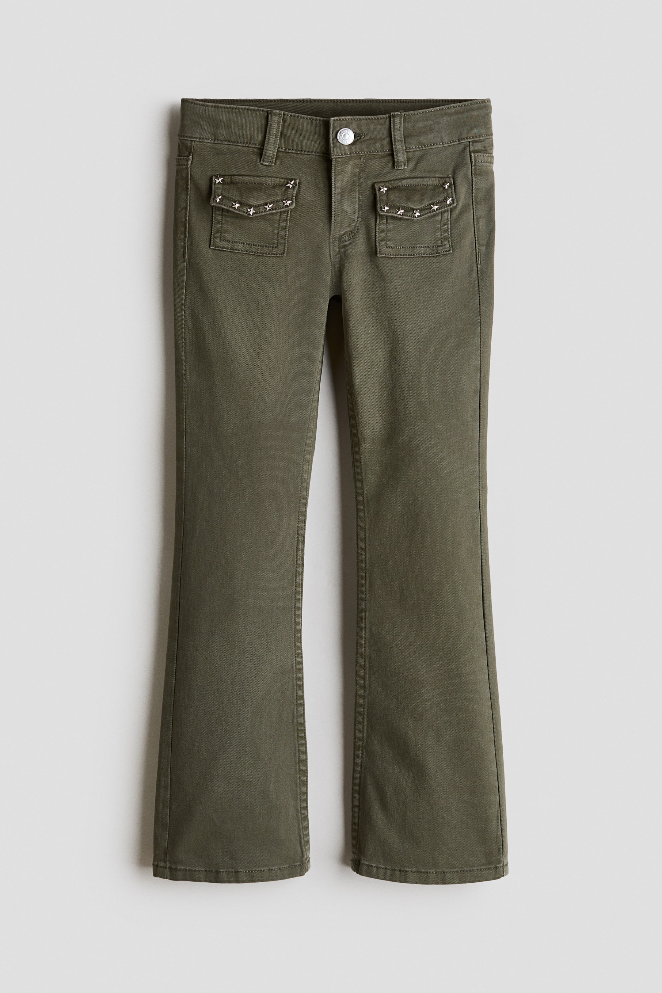 View larger image: Olive green flare trousers are laid flat, showcasing a front view. They feature a button and zip fastening, belt loops, and two front flap pockets embellished with silver-toned star studs, with the legs flaring out from the knee.