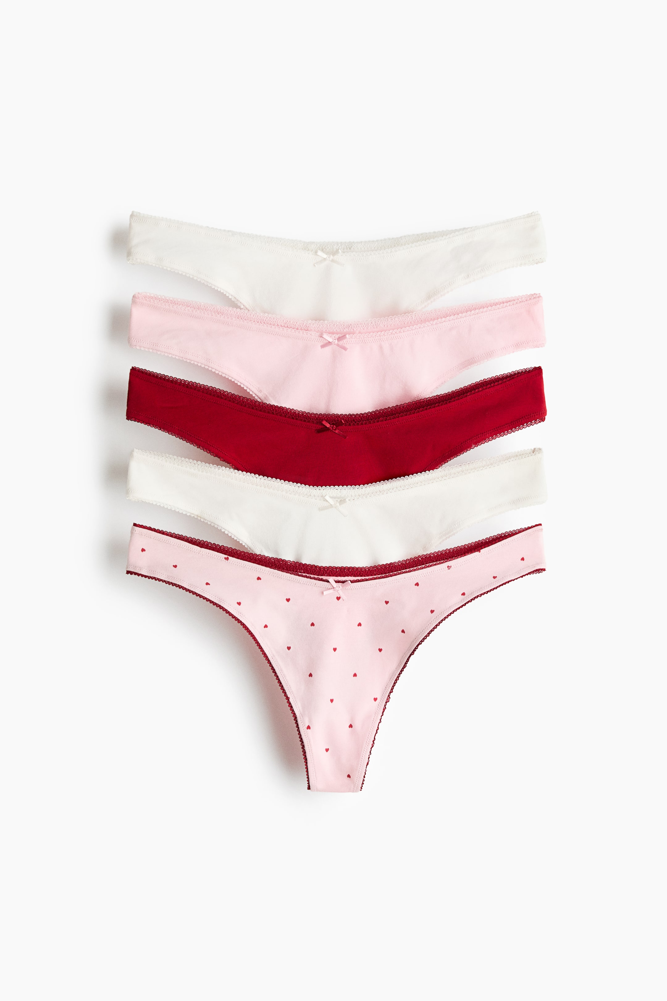 View larger image: Five cotton jersey thong briefs are displayed in a layered FRONT view, each featuring a low, V-shaped waist and a small bow at the center front.