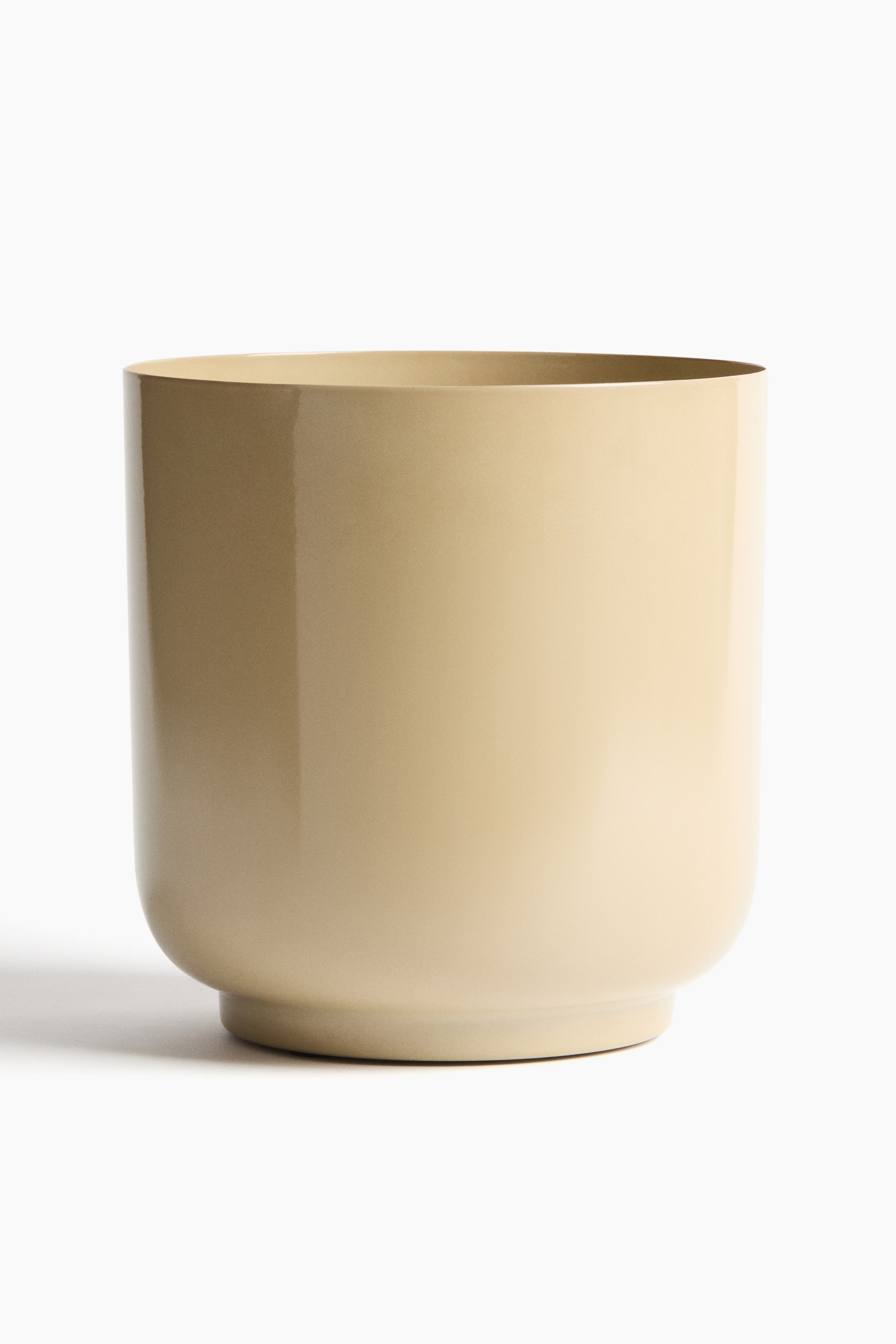 View larger image: A large, front-facing cylindrical metal plant pot features a pale beige colour with a high-gloss finish. Its smooth body tapers slightly to a recessed base.