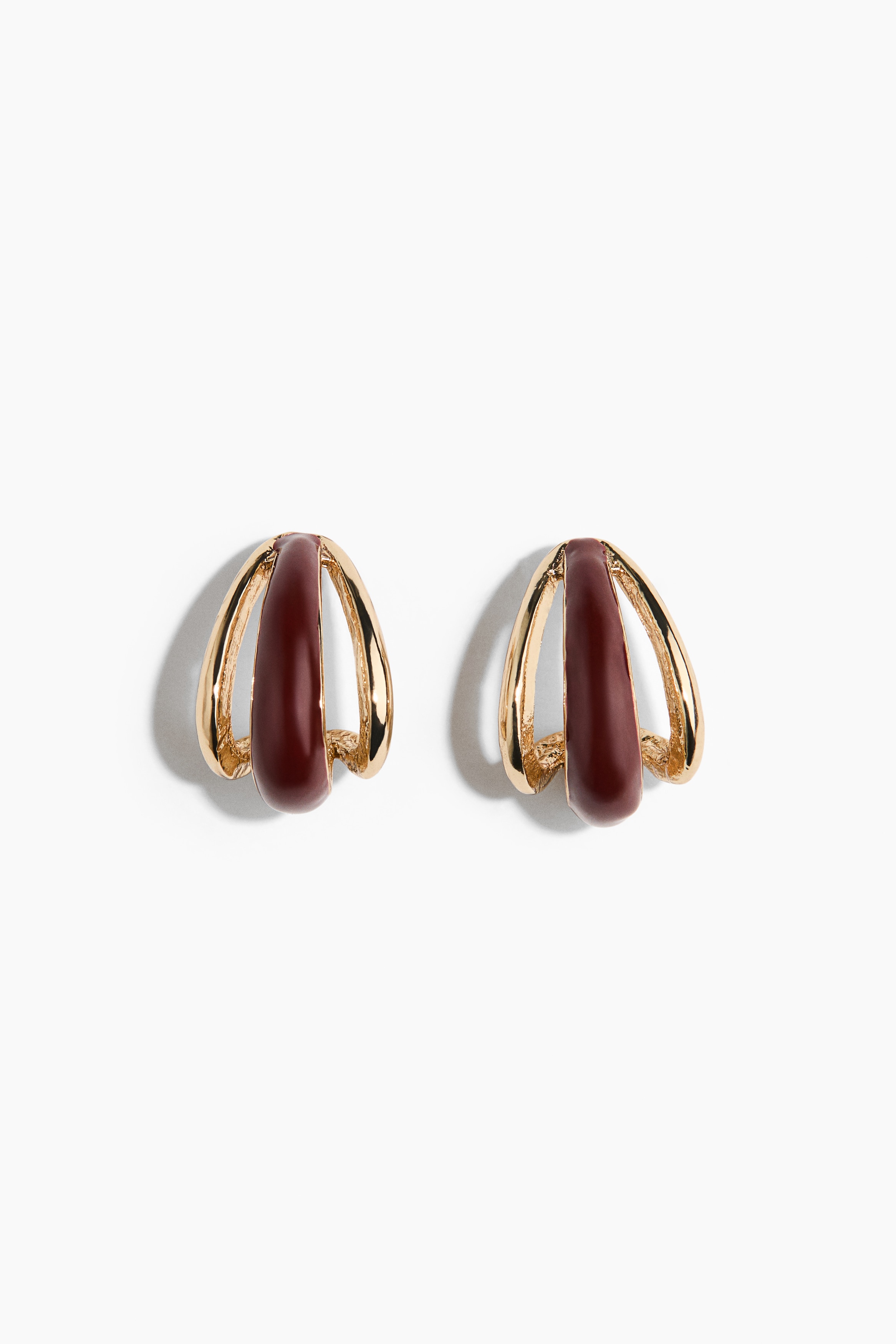 A pair of drop-shaped earrings is displaying a layered, curved design from a front-facing view. The earrings are combining polished gold-toned metal loops with a central, glossy dark brown plastic inlay.