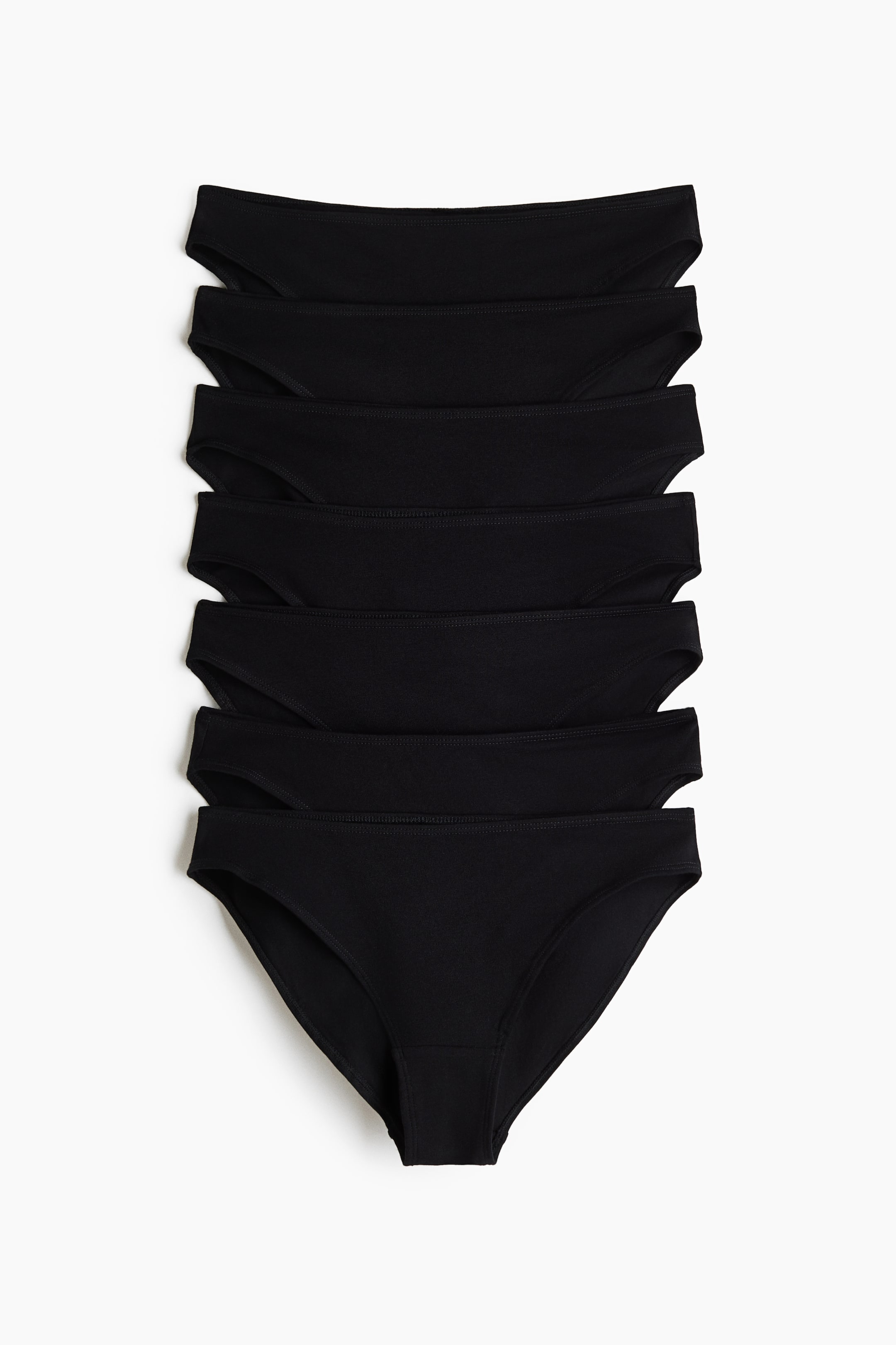 View larger image: Seven black cotton jersey briefs are stacked, with the top brief facing front and featuring a mid-rise design.