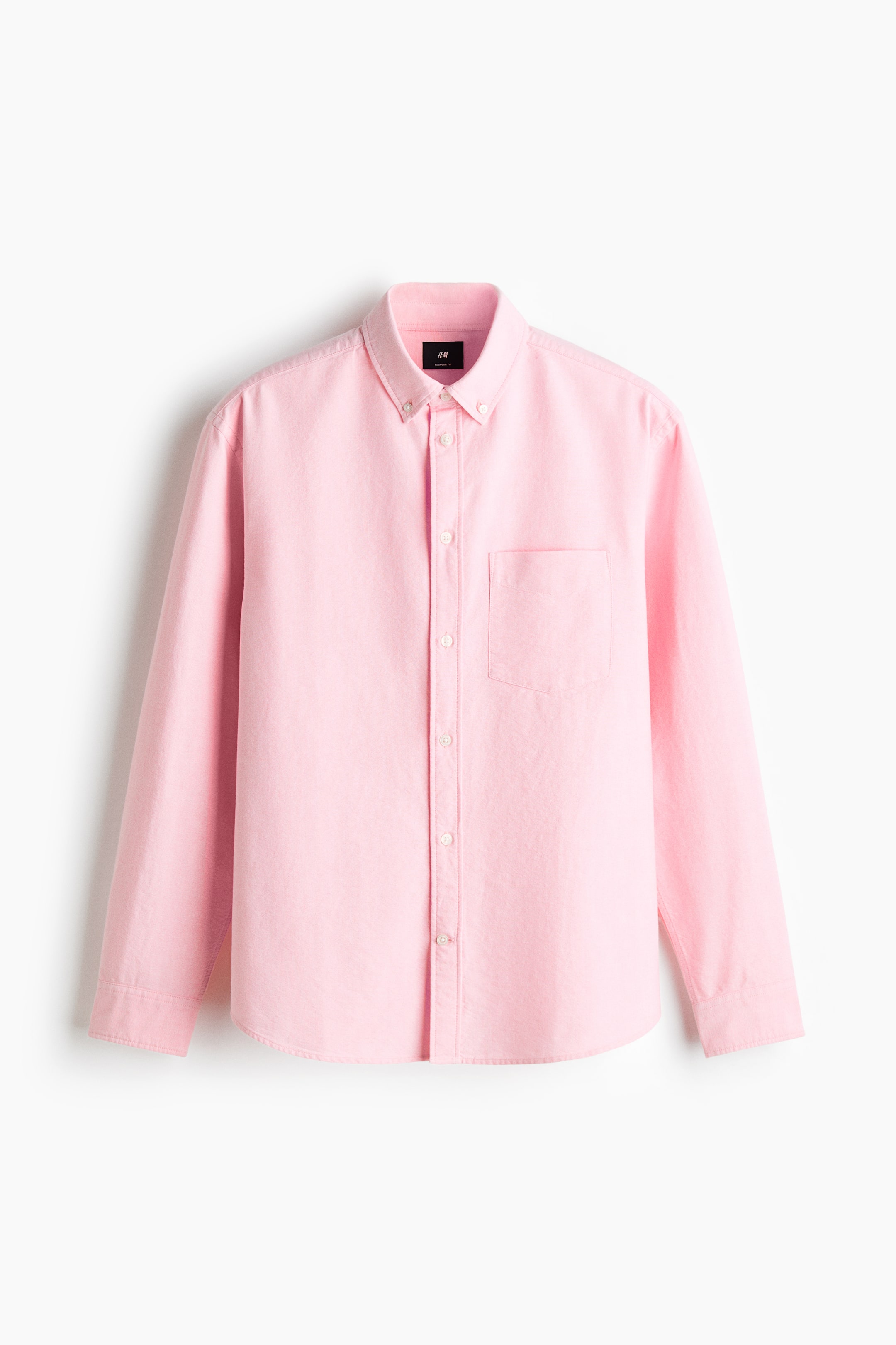 View larger image: The image displays a pink Oxford cotton shirt from the front view, highlighting a button-down collar, a classic button-front placket, and an open chest pocket. It is crafted with long sleeves, buttoned cuffs, a sleeve placket with a link button, and a gently rounded hem.