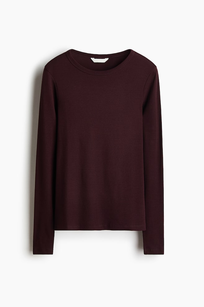A long-sleeved top in dark burgundy ribbed cotton jersey is hanging flat and facing front, displaying a round neckline, long sleeves, and a straight hem. - 1