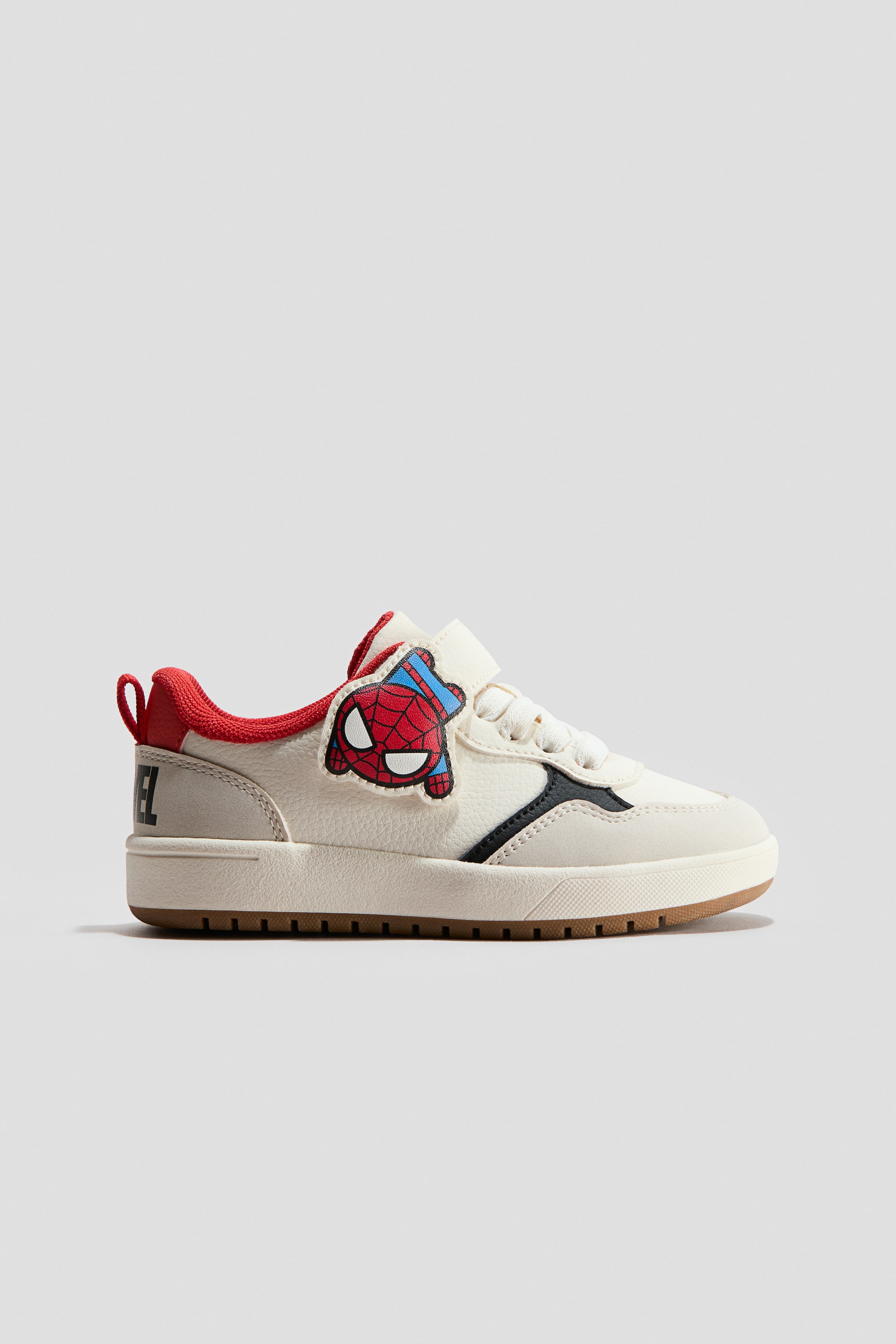 View larger image: Printed trainers showcase an off-white upper with red ankle trim, a black accent panel, and the black 'MARVEL' text on the heel. A red and blue Spider-Man head embellishes the outer side, secured with a hook-and-loop strap, while white laces and a brown outsole complete the design.