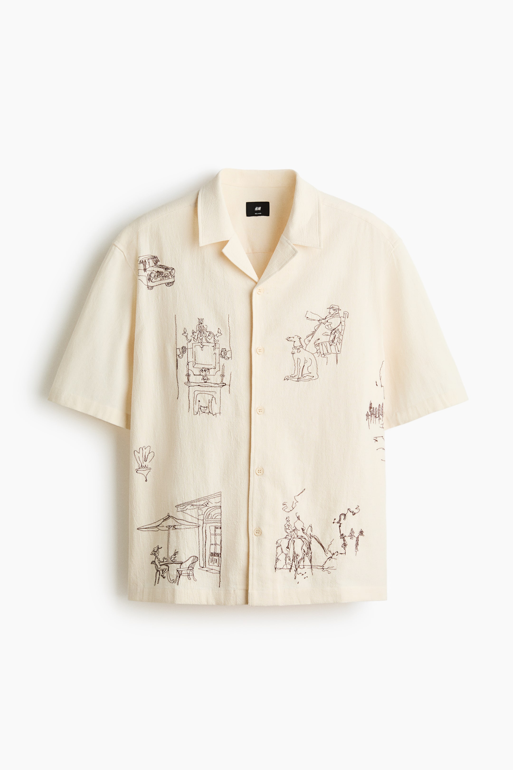 View larger image: A cream short-sleeved shirt in a cotton weave shows the front, featuring a resort collar and a clean French front. The relaxed-fit shirt, with a straight hem, displays various dark brown embroidered motifs across its surface.