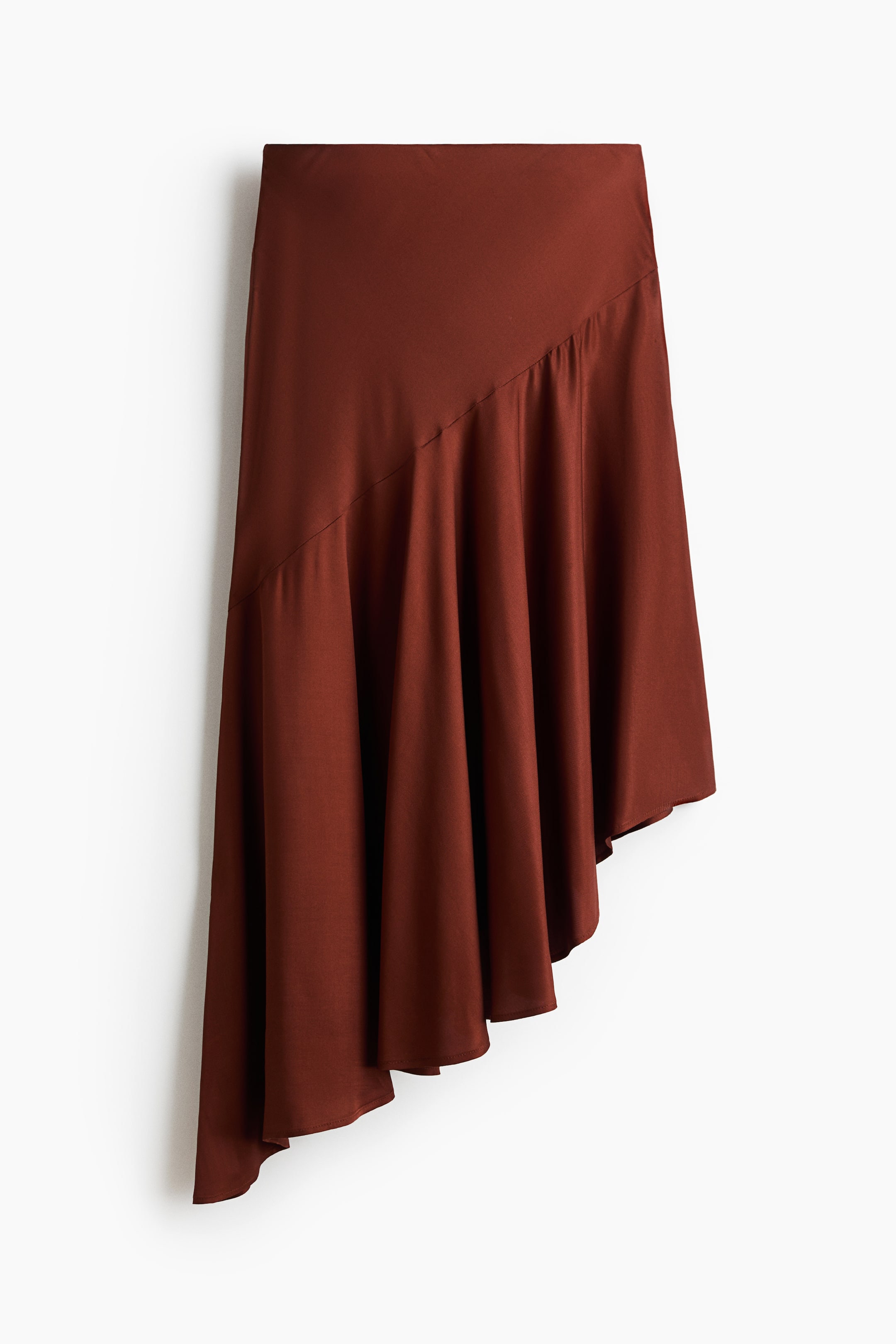 View larger image: Presenting a brown midi skirt from the front view, this piece showcases a fitted high waist and a diagonal seam across the hips. Below this seam, the bias-cut section creates a flowing, billowing silhouette with an asymmetric hem.