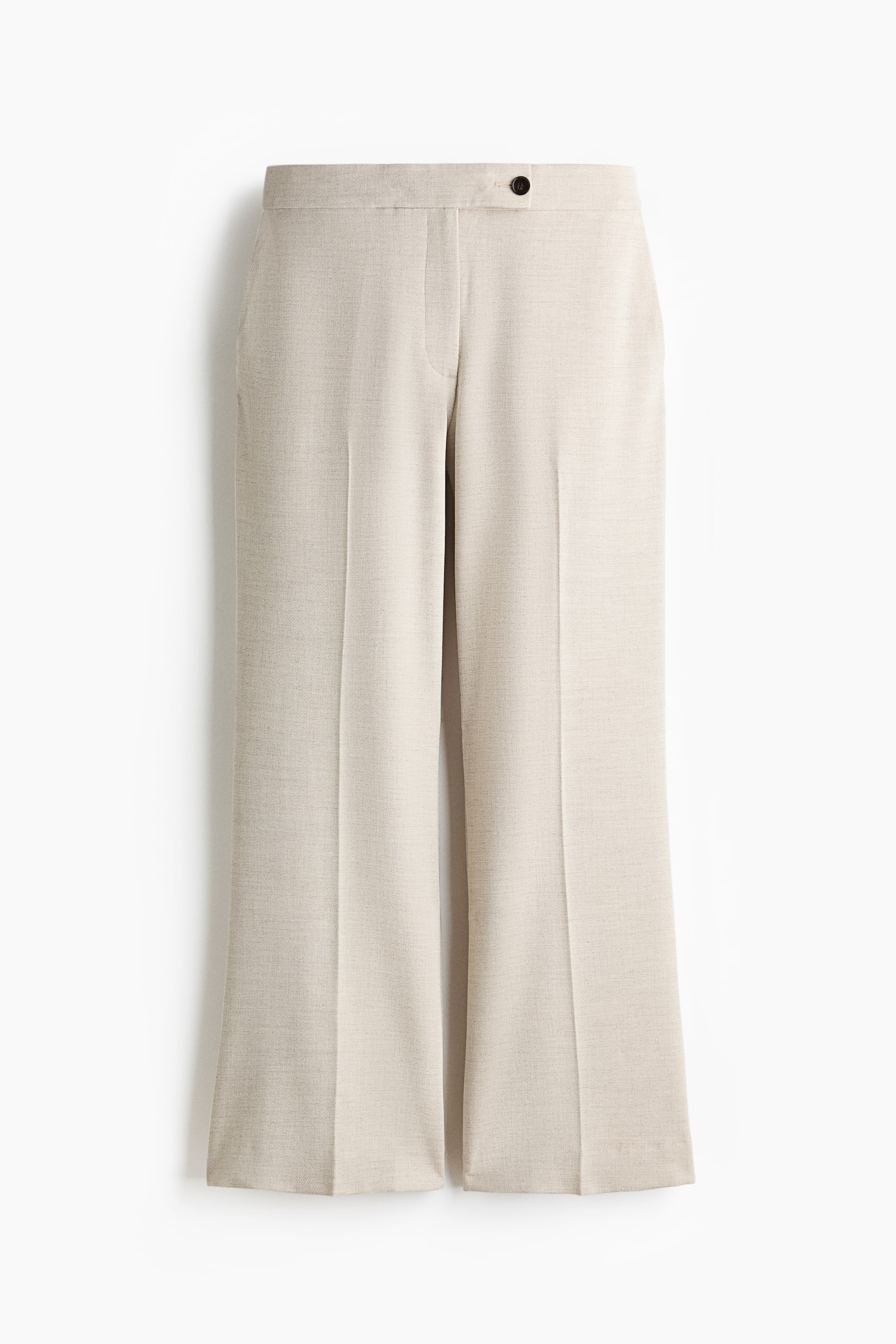 View larger image: Light beige pants in a subtly textured fabric, shown from the front. They feature a flat waistband with a single dark button closure, and wide legs fall from the waist with crisp front creases down to straight hems.