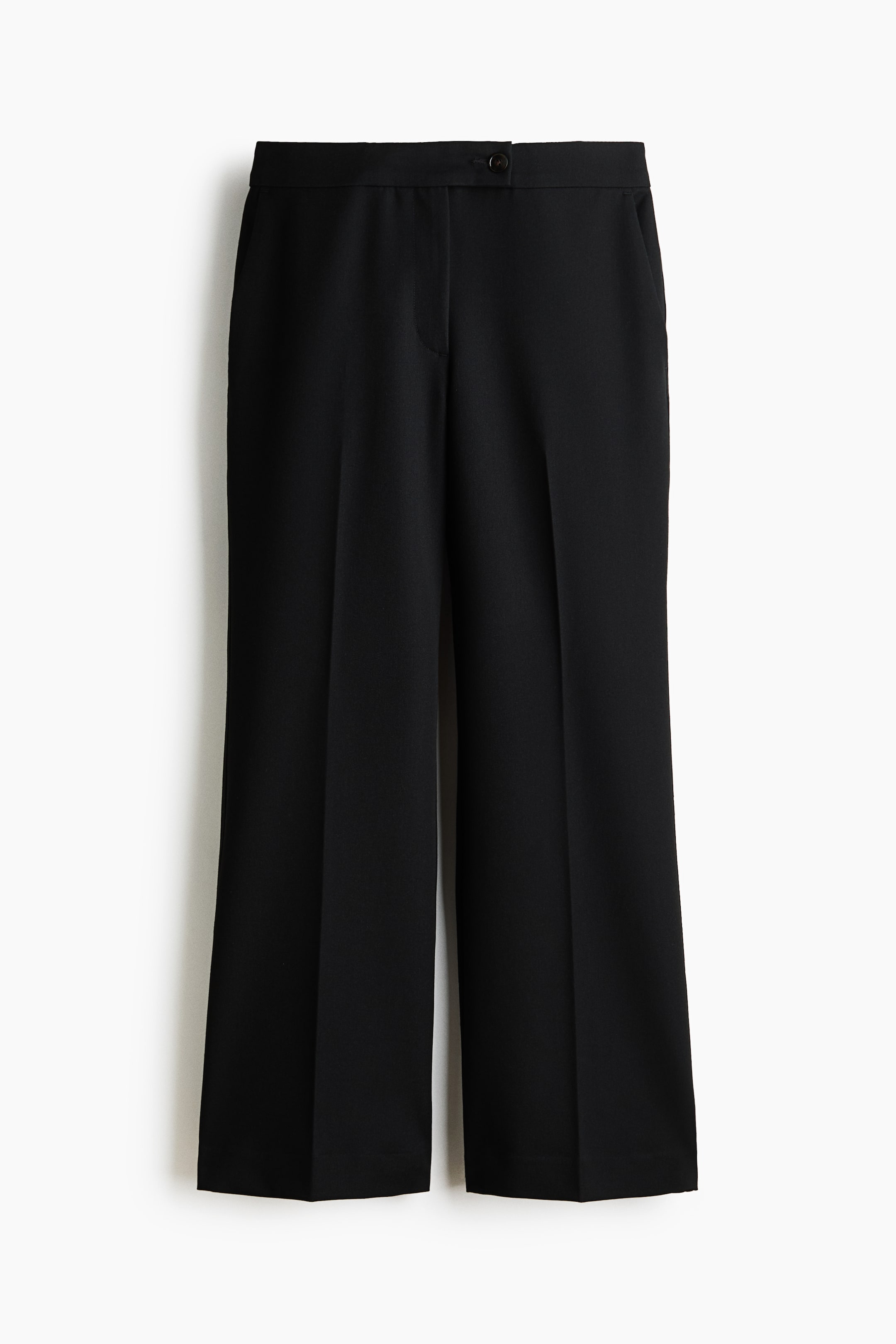 View larger image: Black pants display a flat waistband with a single black button closure, discreet side pockets, and sharp vertical creases running down the front of each wide leg.