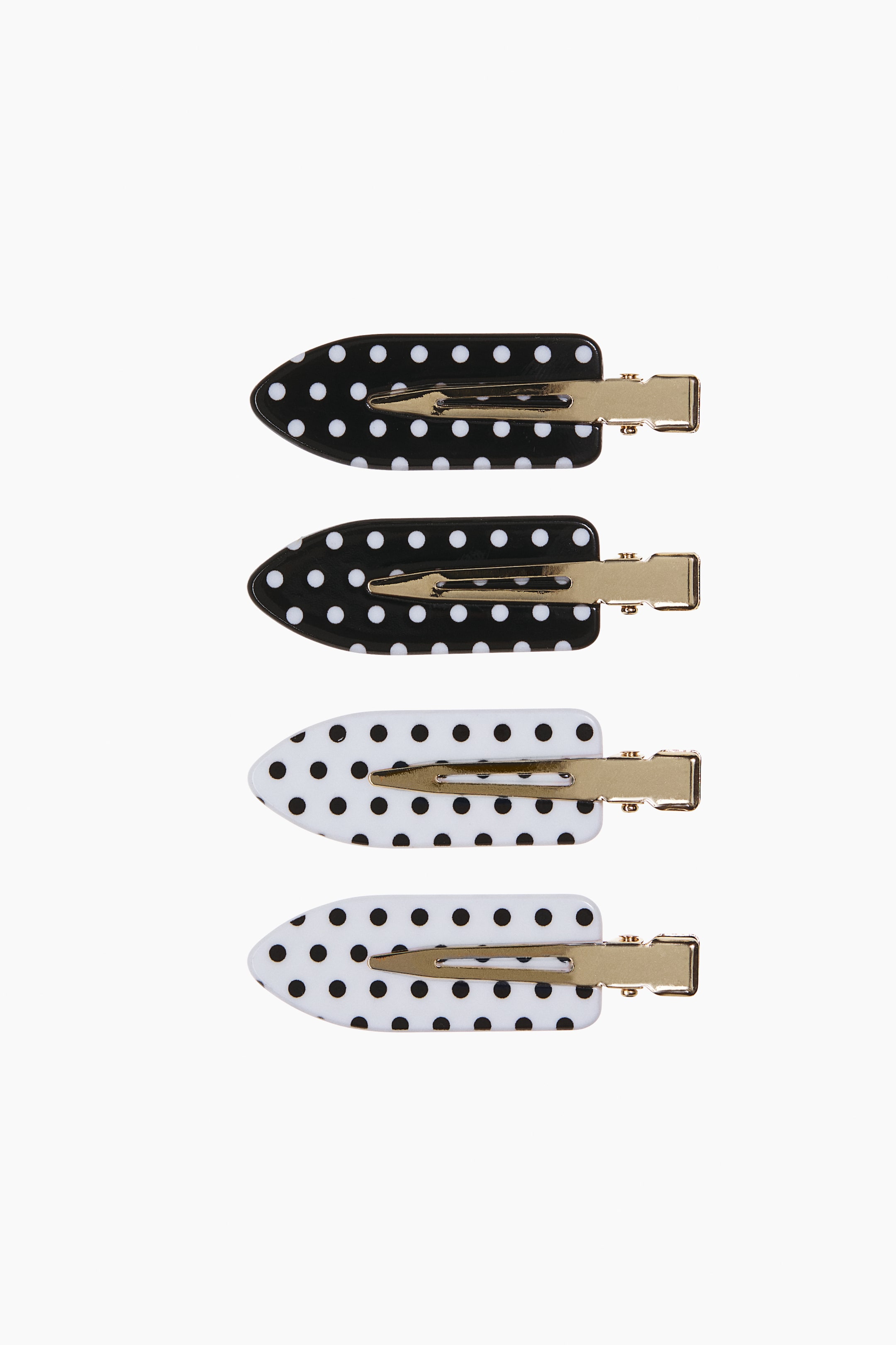 Agrandir l'image: Quatre barrettes plates en forme de feuille sont présentées de face, dont deux barrettes noires à pois blancs et deux barrettes blanches à pois noirs. Chaque barrette est conçue avec une plaque lisse et arrondie, et une pince crocodile en métal doré courant le long du centre.