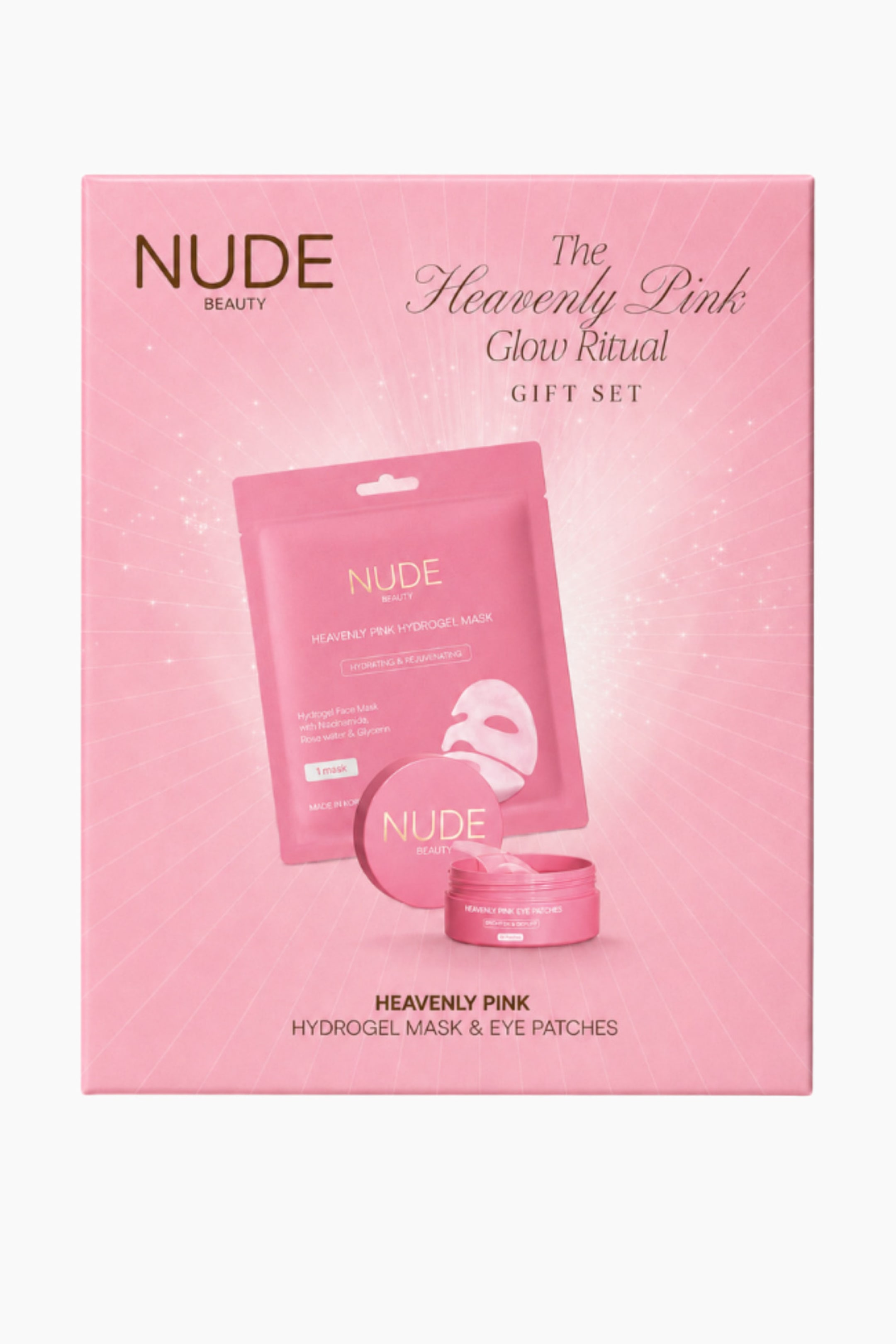 Vis større bilde: Nude Beauty Heavenly Pink Glow Ritual-gavesettet vises forfra, med en rektangulær rosa eske med et strålende stjernelysmønster. Forsiden av emballasjen viser merkevarenavnet og produktnavnet, sammen med grafikk av den medfølgende rosa hydrogel-maske-posen og en matchende rosa krukke med øyepatches.