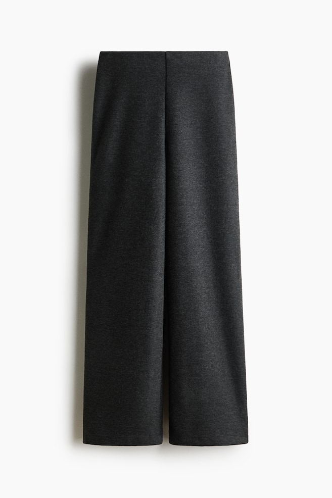 Dark grey knitted trousers are hanging straight from a front view, showcasing a soft, textured knit fabric and a straight-leg silhouette. The design features a clean elasticated waistband and a relaxed fit. - 1